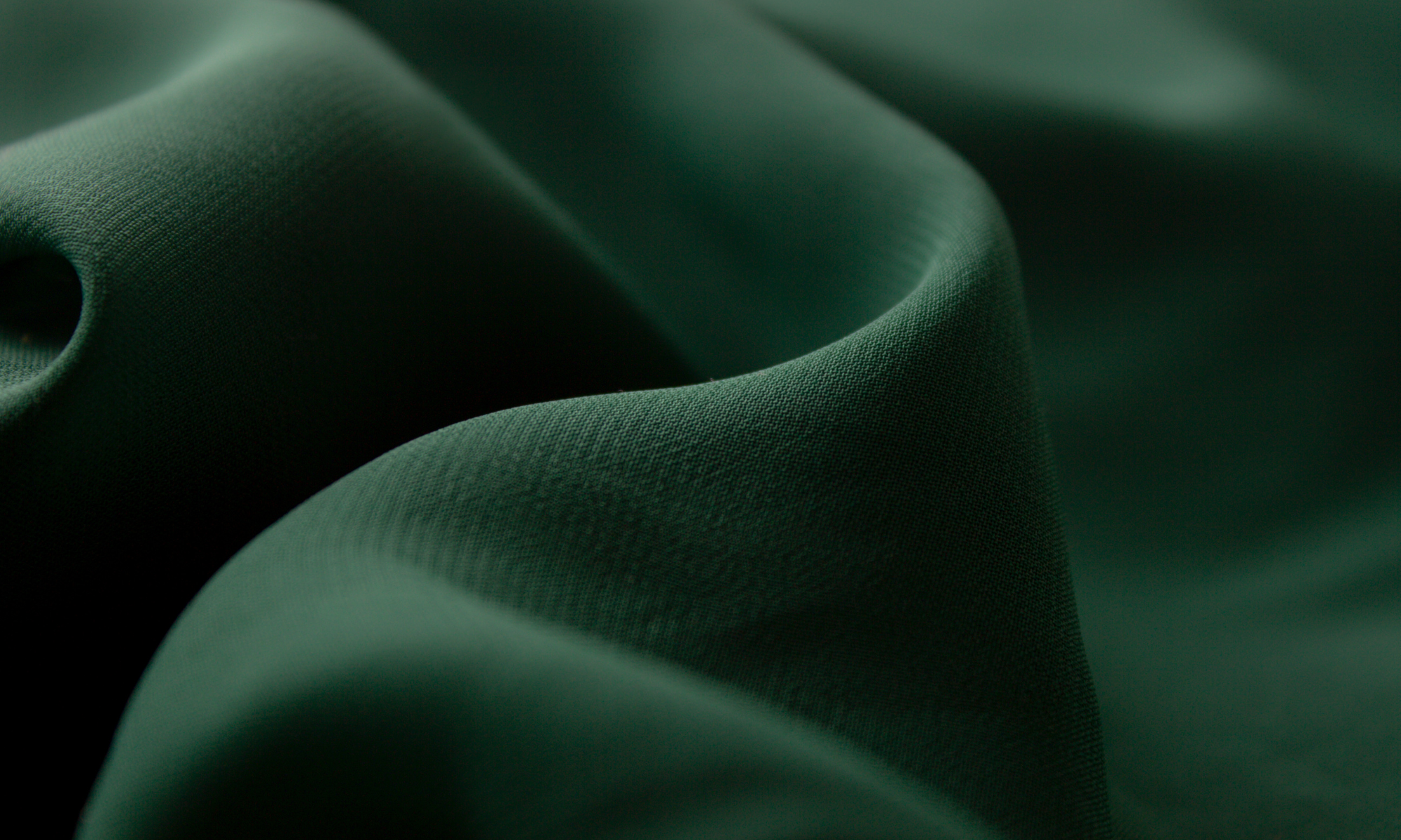 Close-up of dark green fabric texture