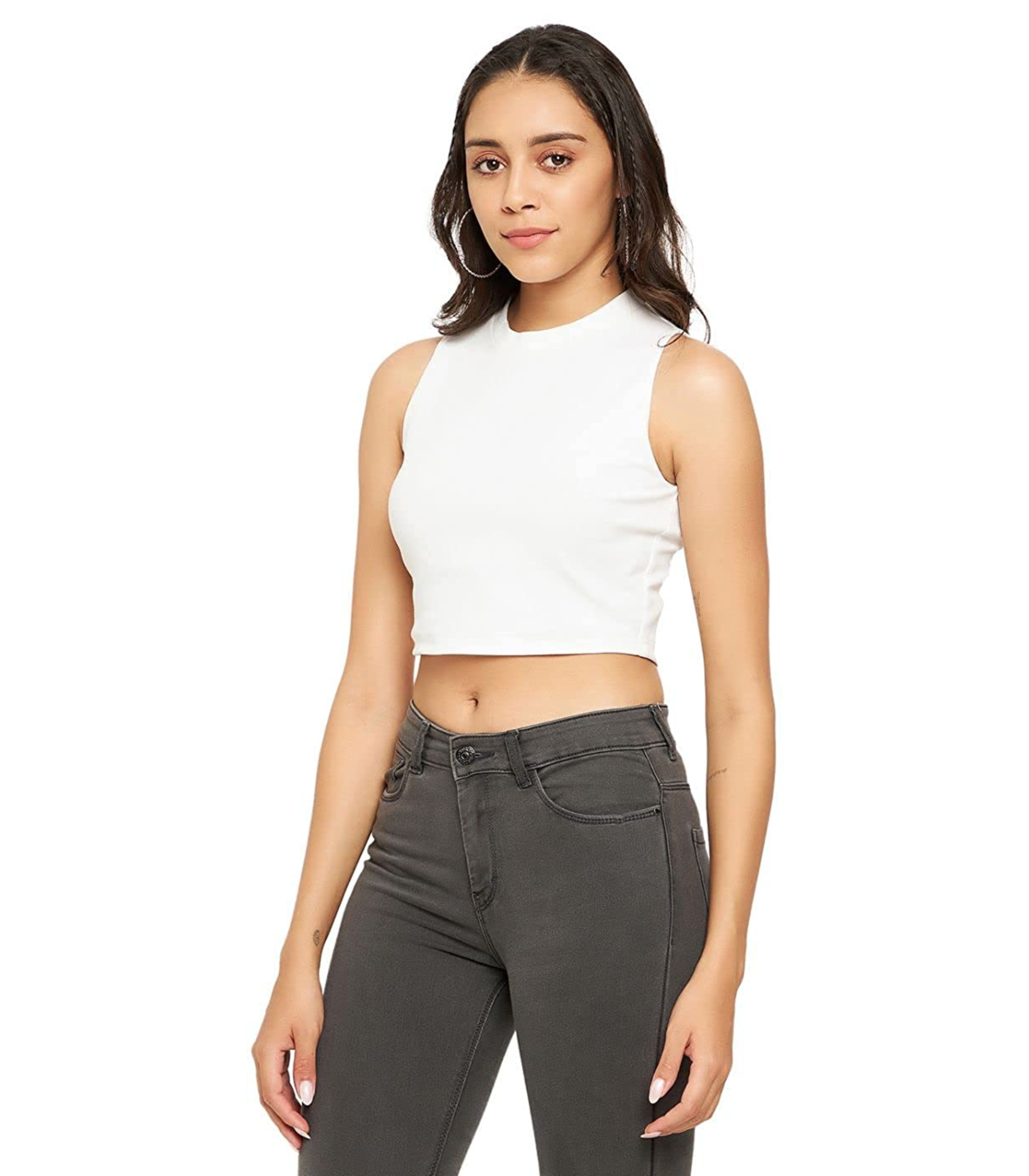 Woman wearing a white sleeveless top and gray jeans on a white background