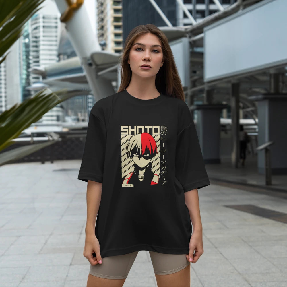 Person wearing a black t-shirt with a graphic design in an urban setting