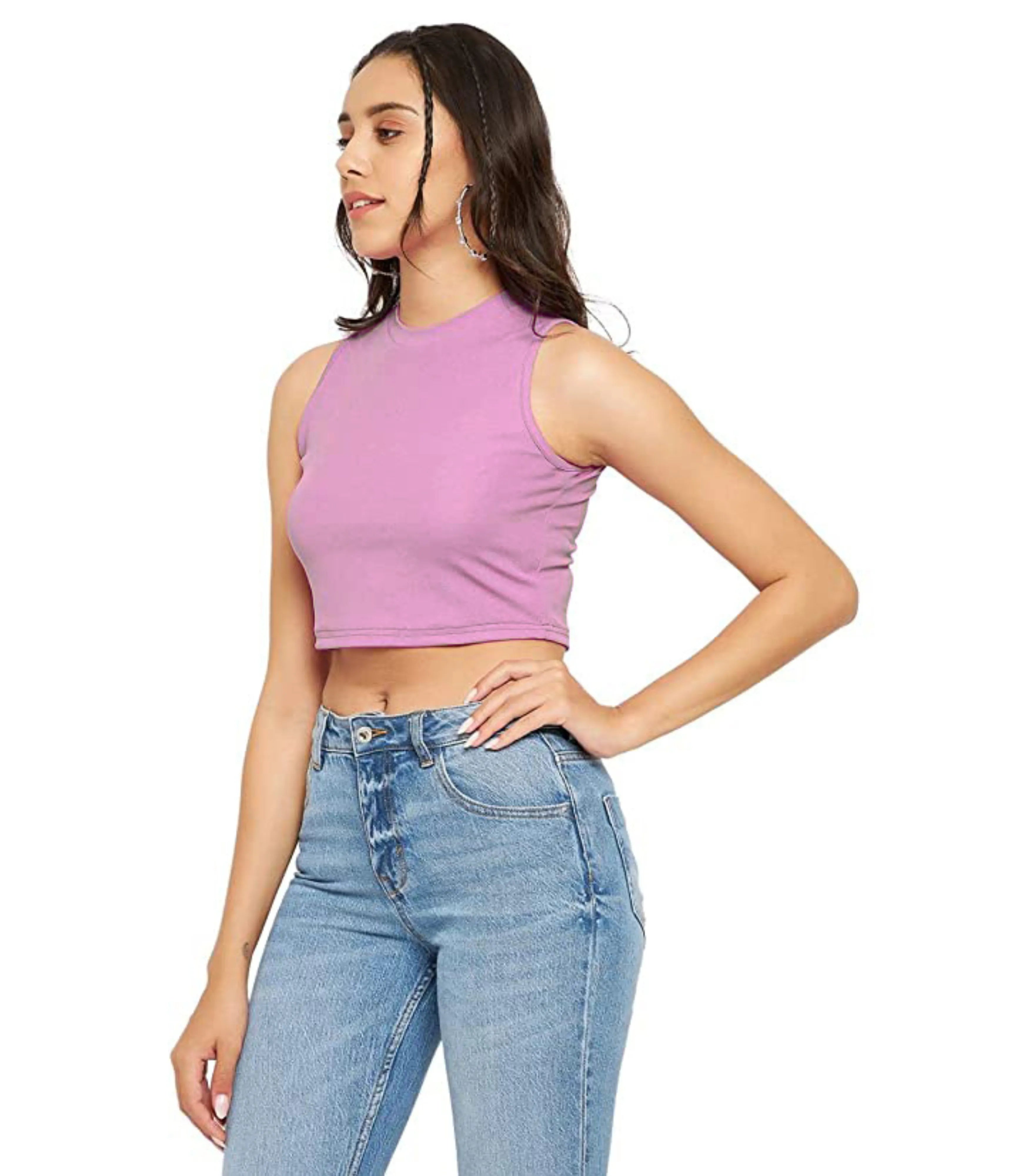 Woman wearing a purple sleeveless top and blue jeans on a white background