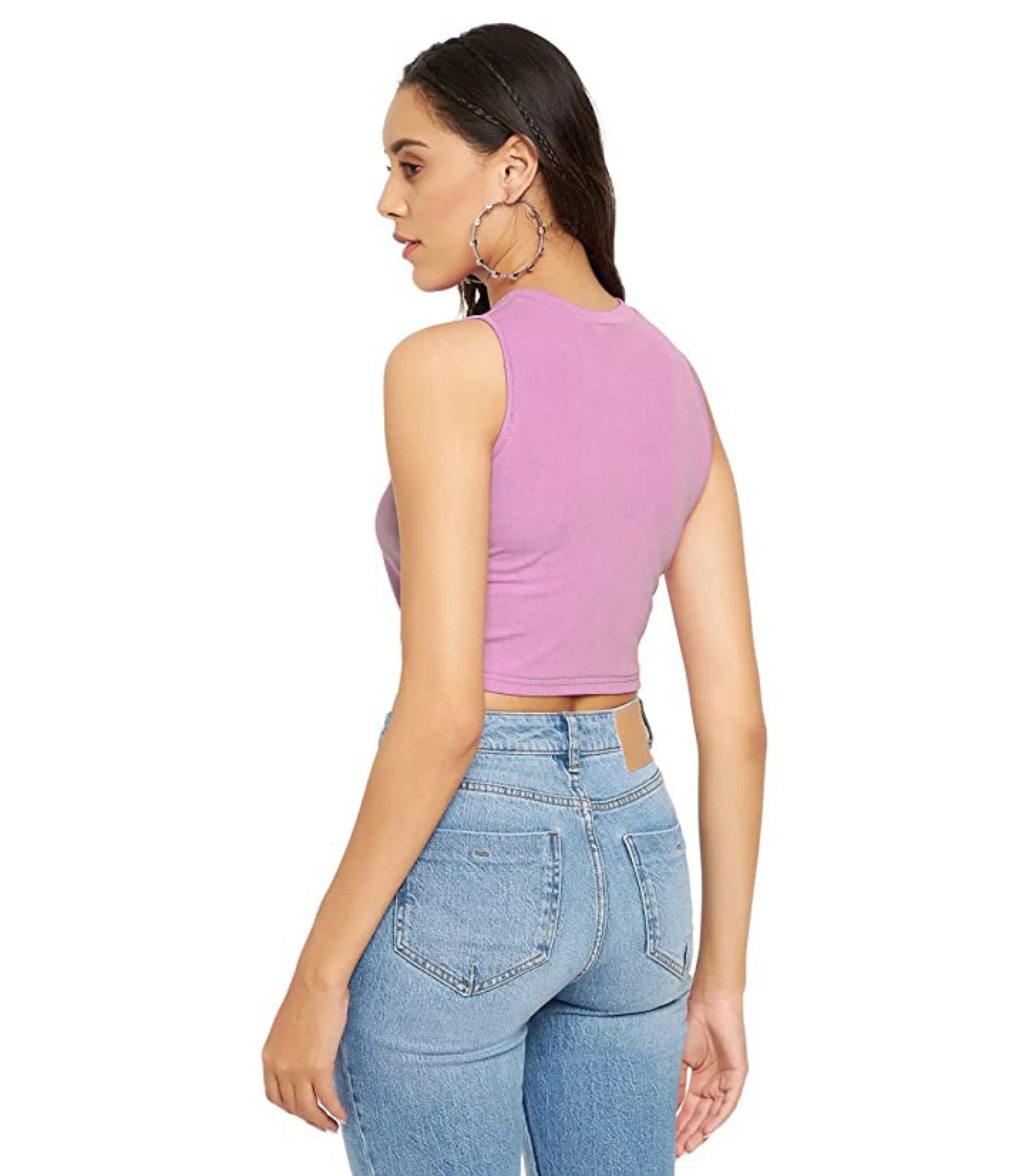 Woman wearing a purple tank top and blue jeans on a white background