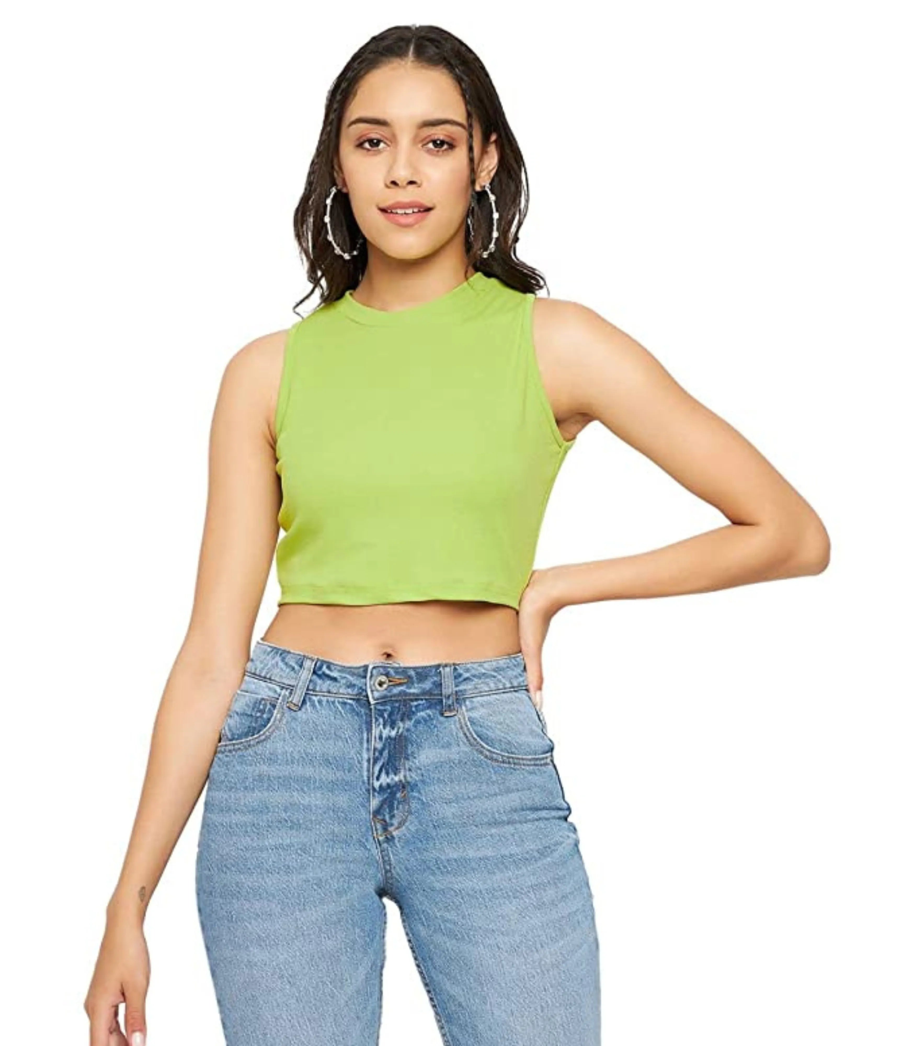 Woman wearing a green sleeveless top and blue jeans on a white background