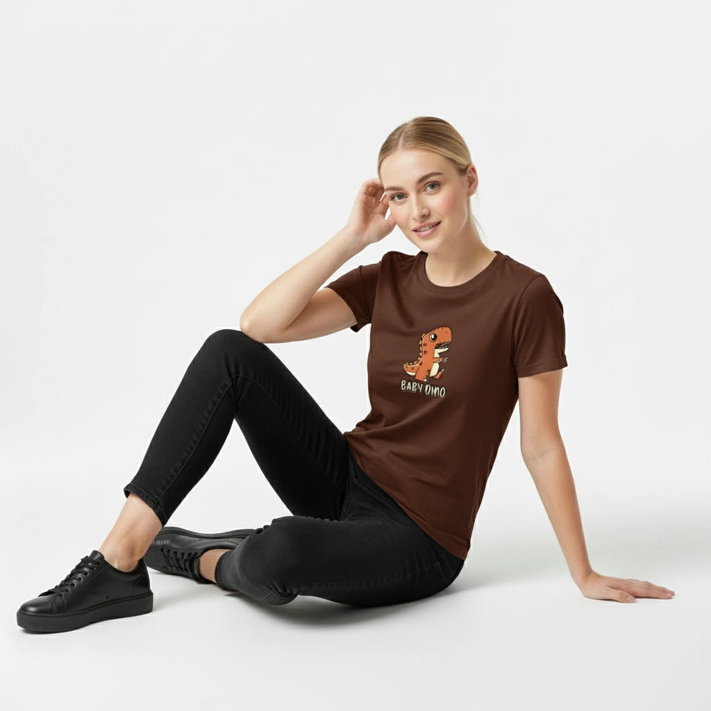 Woman wearing a brown t-shirt with a logo, sitting on a white background