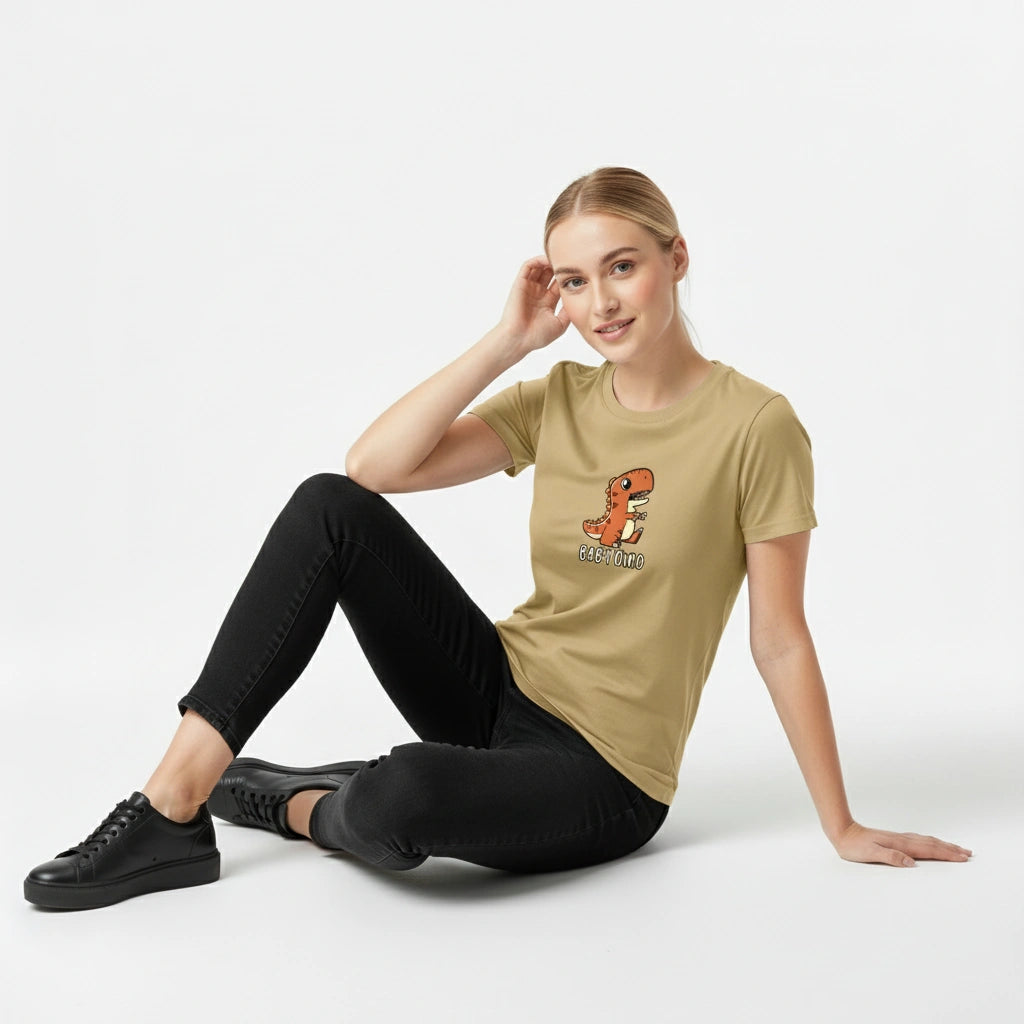 Woman wearing a beige t-shirt with a graphic design, sitting on a white background