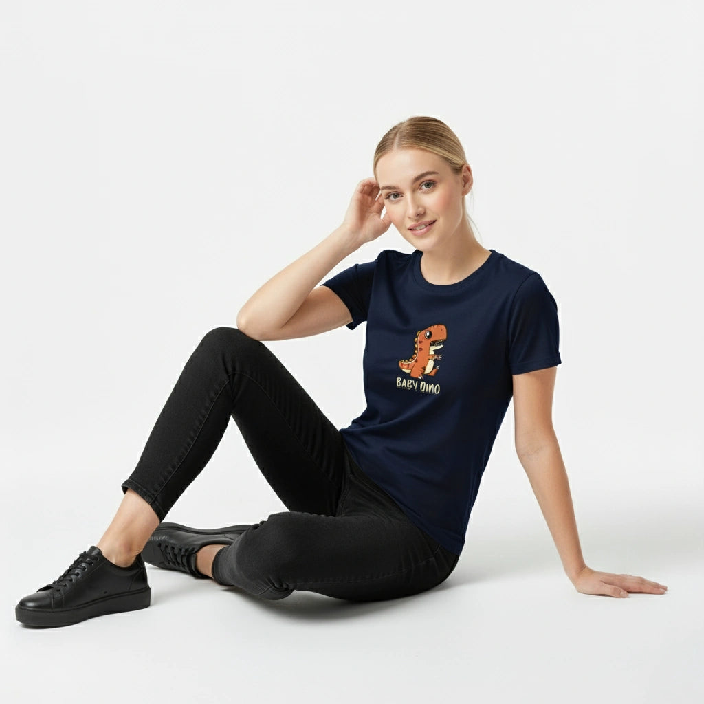 Woman wearing a navy blue t-shirt with a graphic design sitting on a white background
