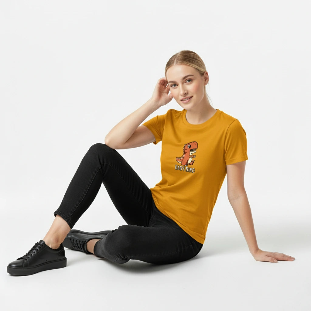 Person wearing a mustard yellow t-shirt with a graphic design, sitting on a white background