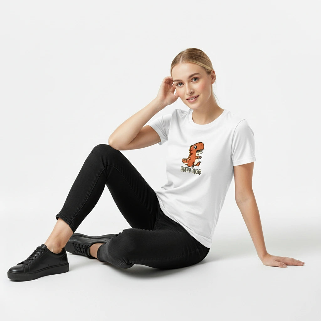 Woman wearing a white t-shirt with a dinosaur graphic and text, sitting on a white background
