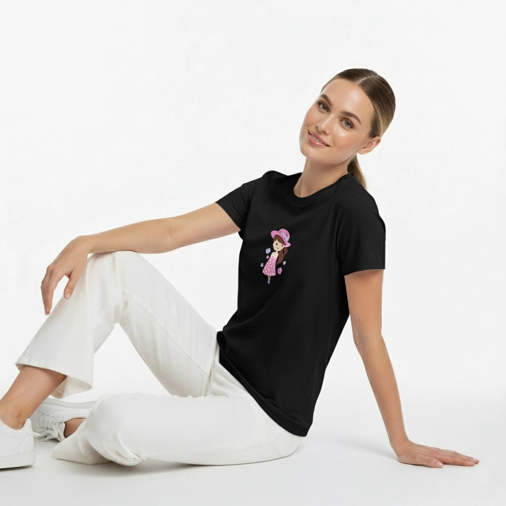 Woman wearing a black t-shirt with a graphic design sitting on a white background
