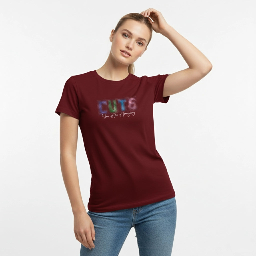 Woman wearing a maroon t-shirt with colorful text on a white background