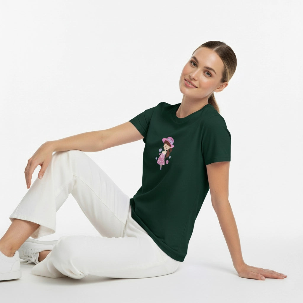 Woman wearing a green t-shirt with a graphic design sitting on a white background