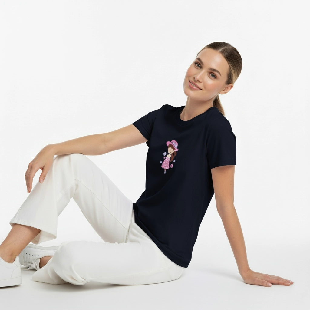 Woman wearing a navy blue t-shirt with a graphic design, sitting on a white background