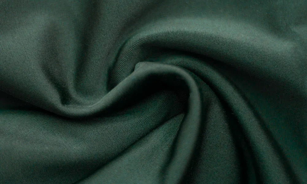 Close-up of dark green fabric with folds