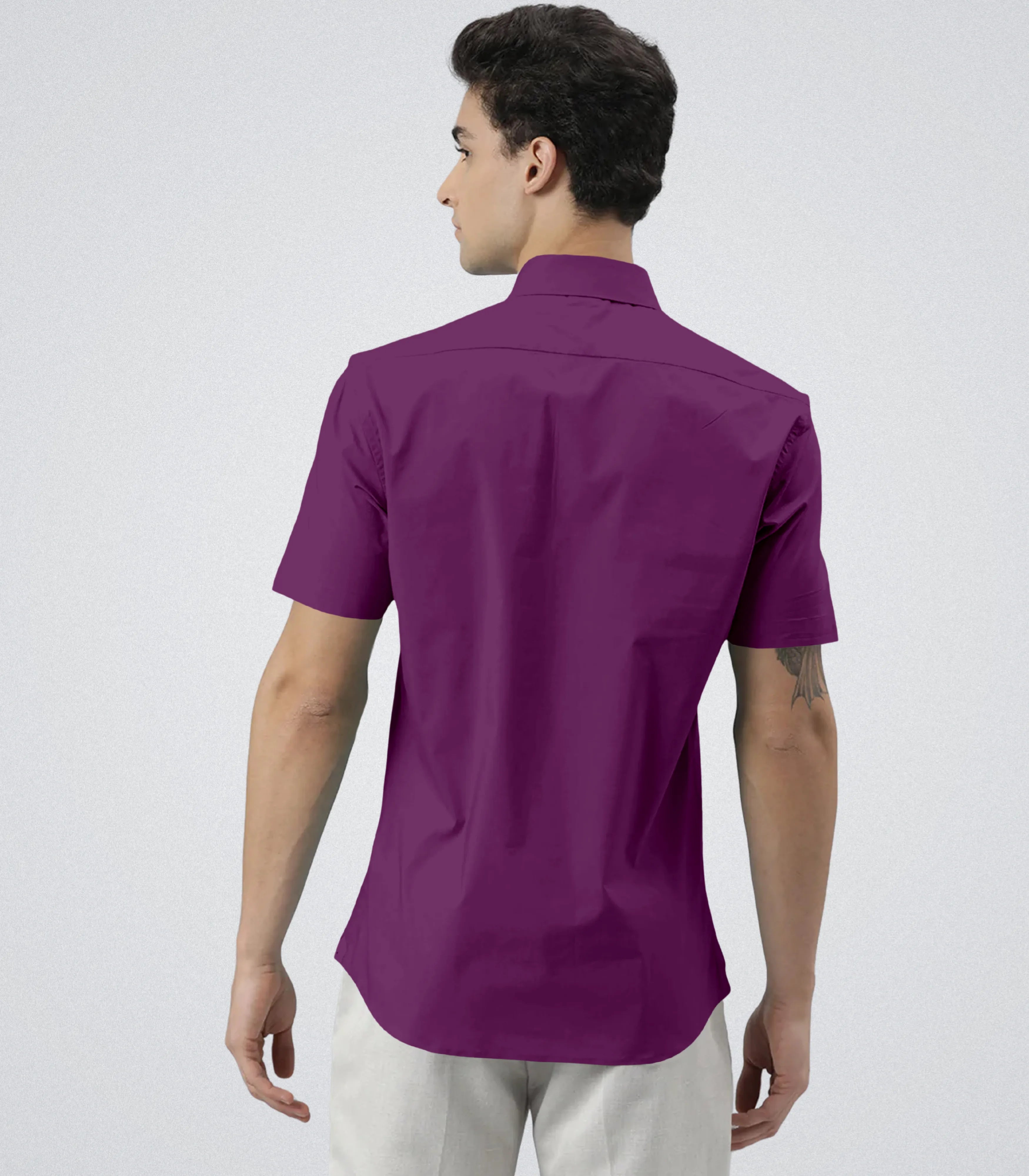 Man wearing a purple shirt on a white background
