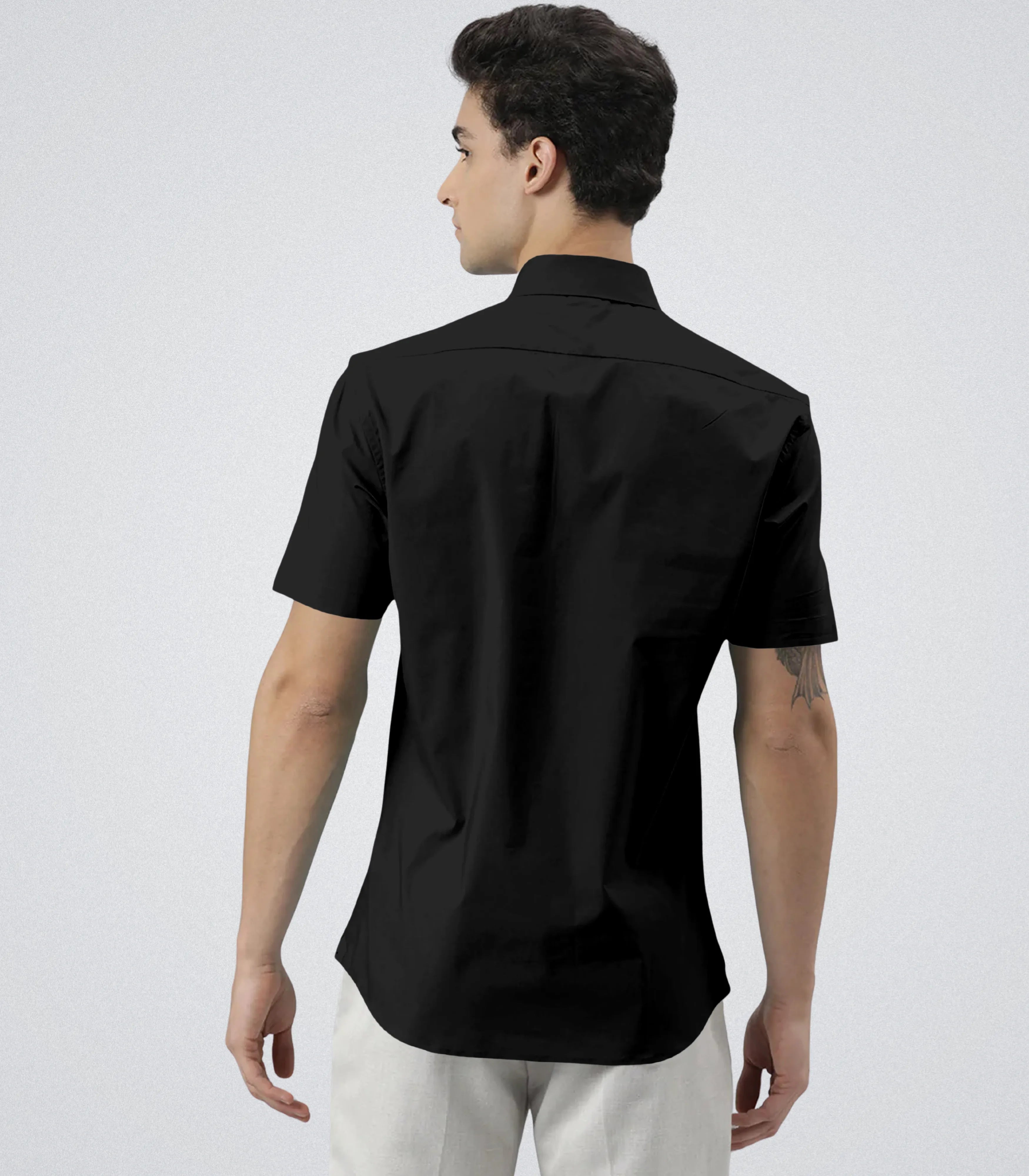 Man wearing a black short-sleeve shirt on a white background