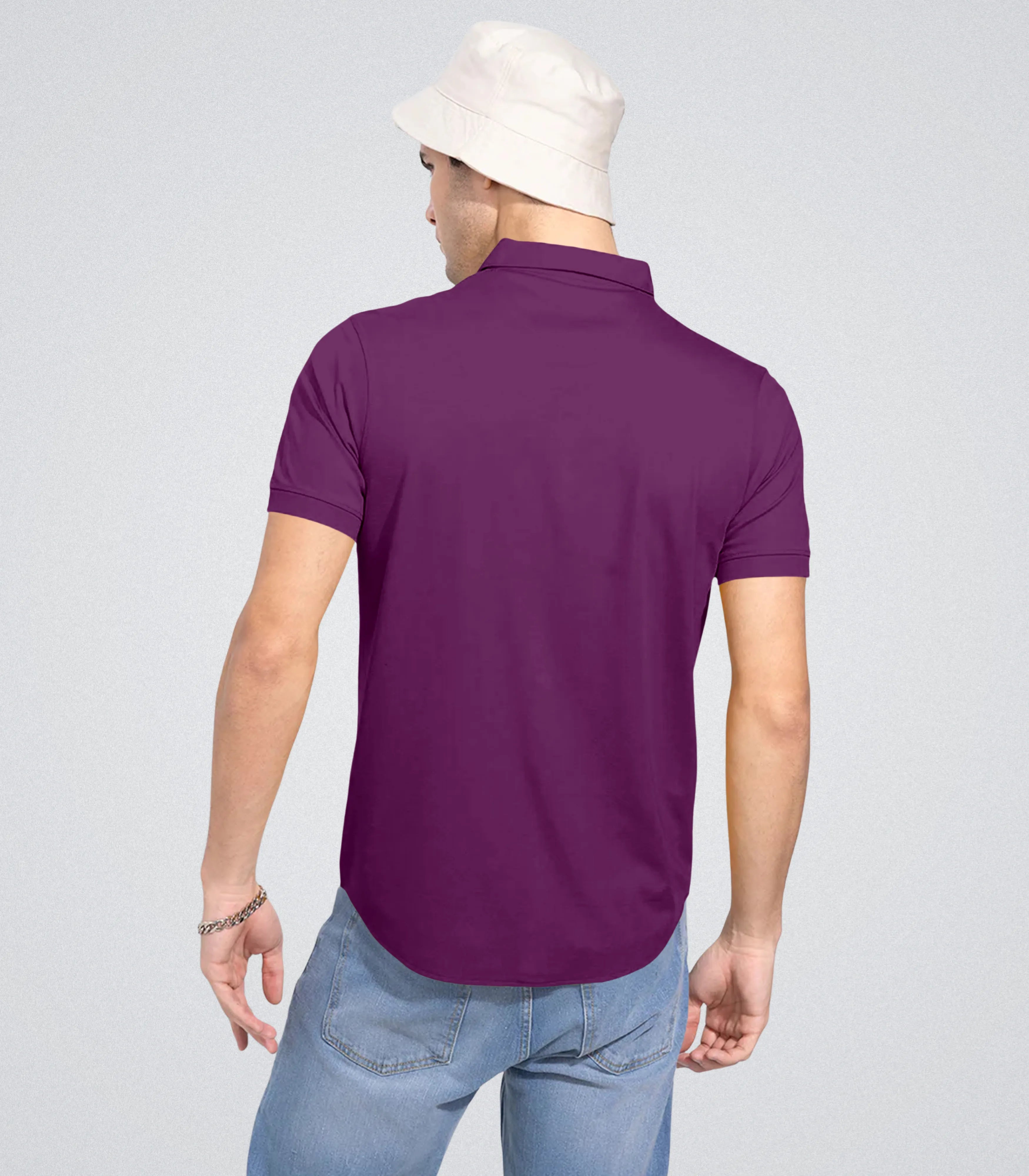 Person wearing a purple polo shirt on a plain background