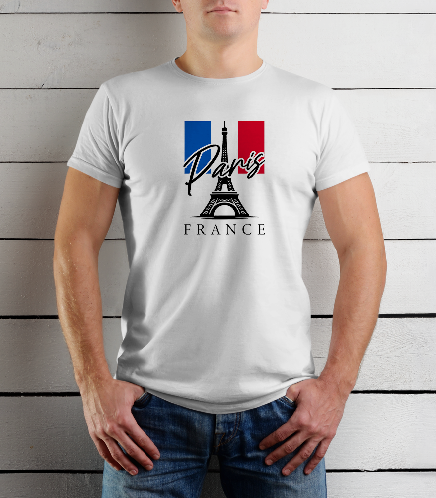Person wearing a white t-shirt with Paris and France design against a wooden background