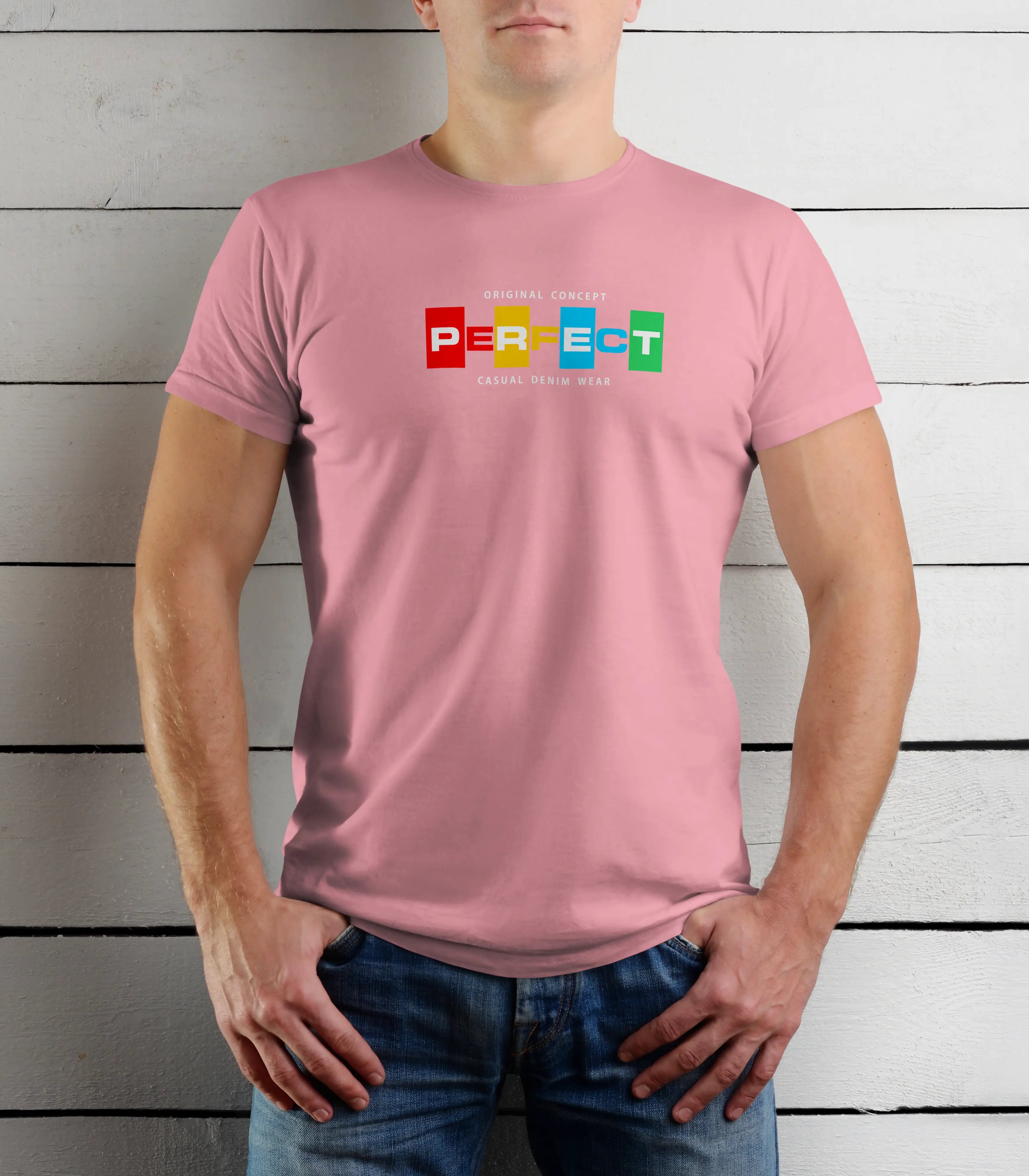 Person wearing a pink t-shirt with colorful text design against a wooden background