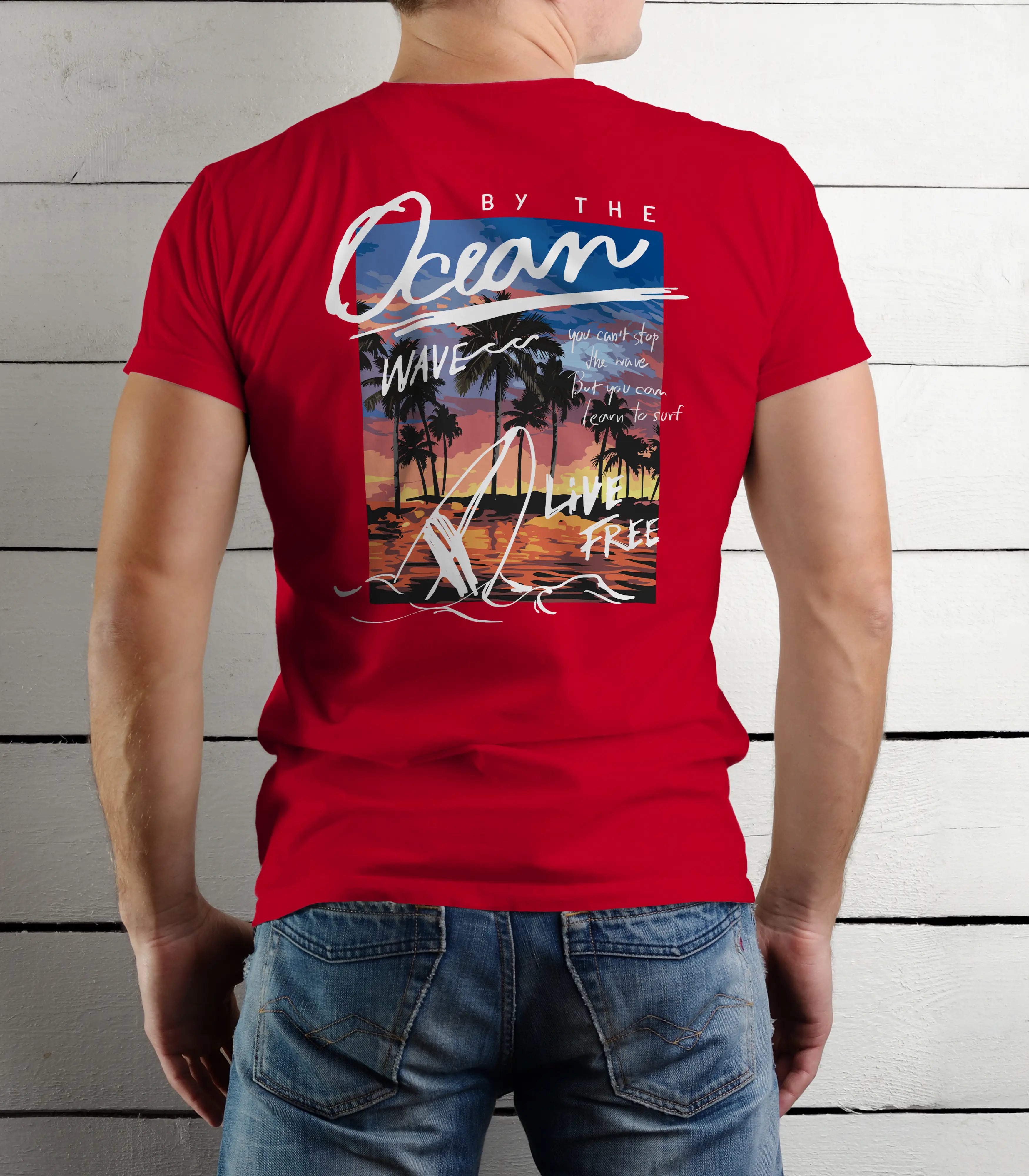 Red t-shirt with a beach-themed design on the back, worn by a person against a wooden panel background.