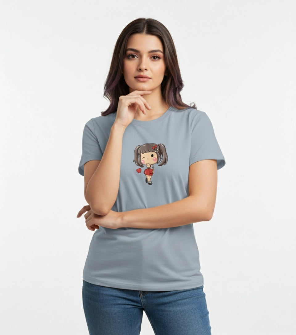 Woman wearing a light blue t-shirt with a cartoon character design on a plain background