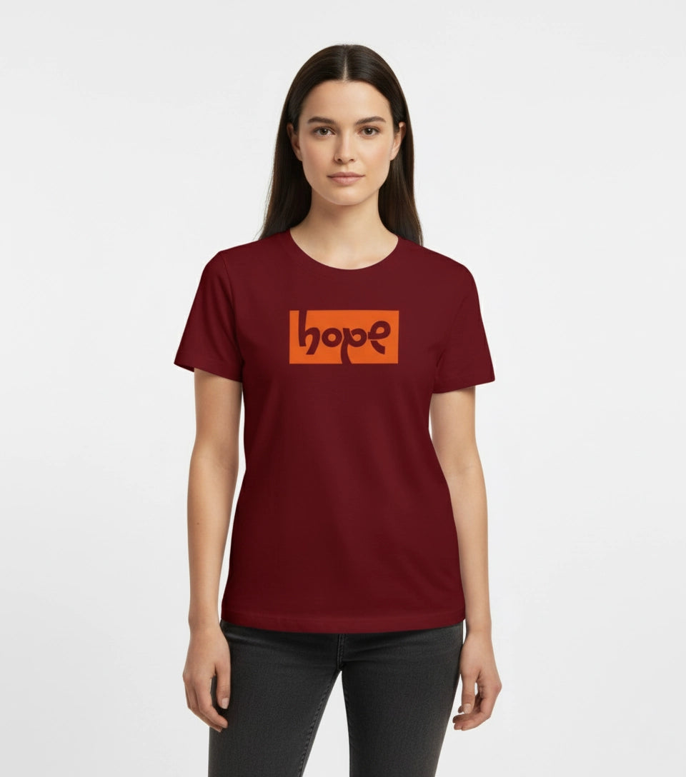 Woman wearing a maroon t-shirt with an orange 'hope' logo on a white background