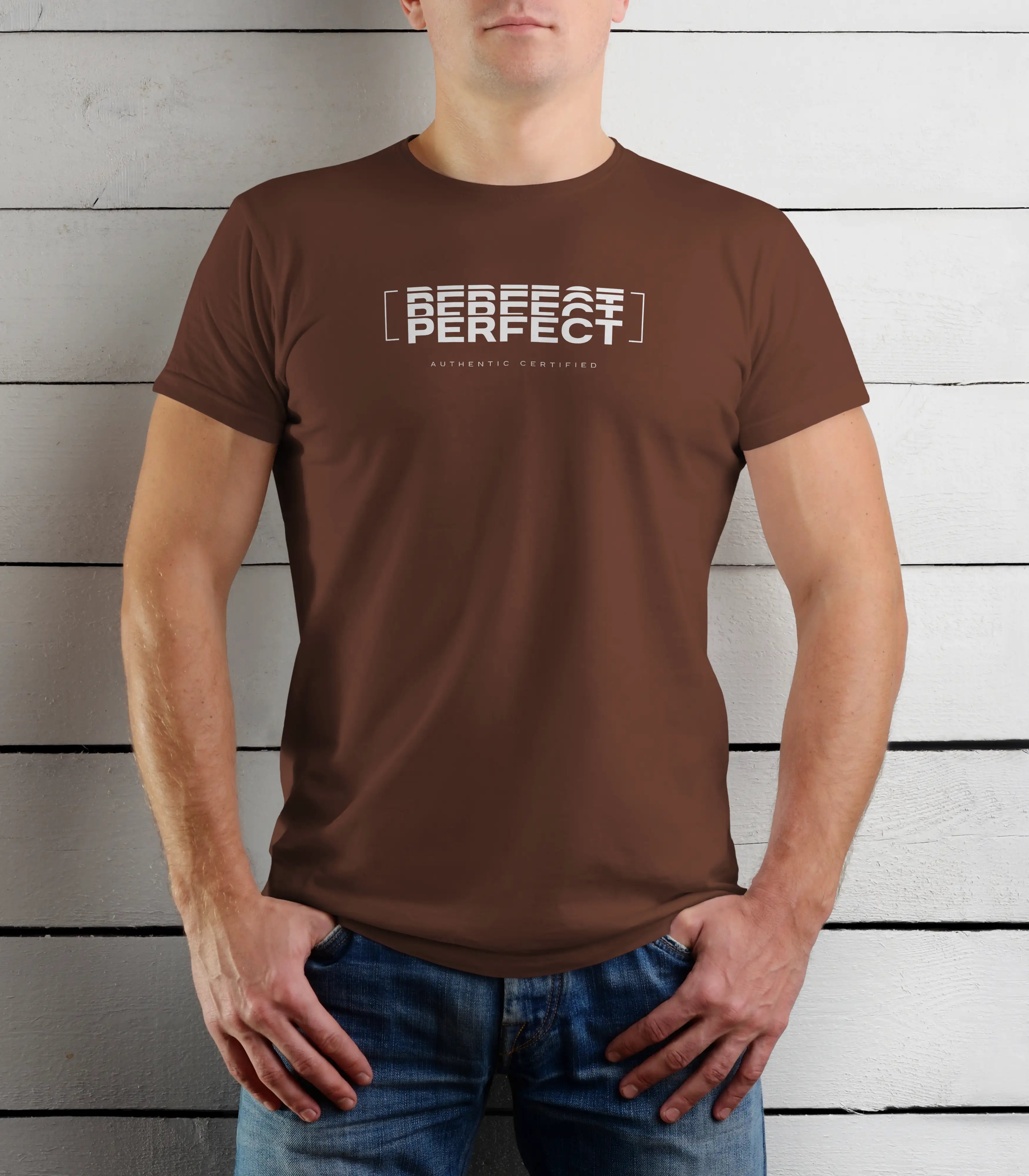 Person wearing a brown t-shirt with text against a wooden background
