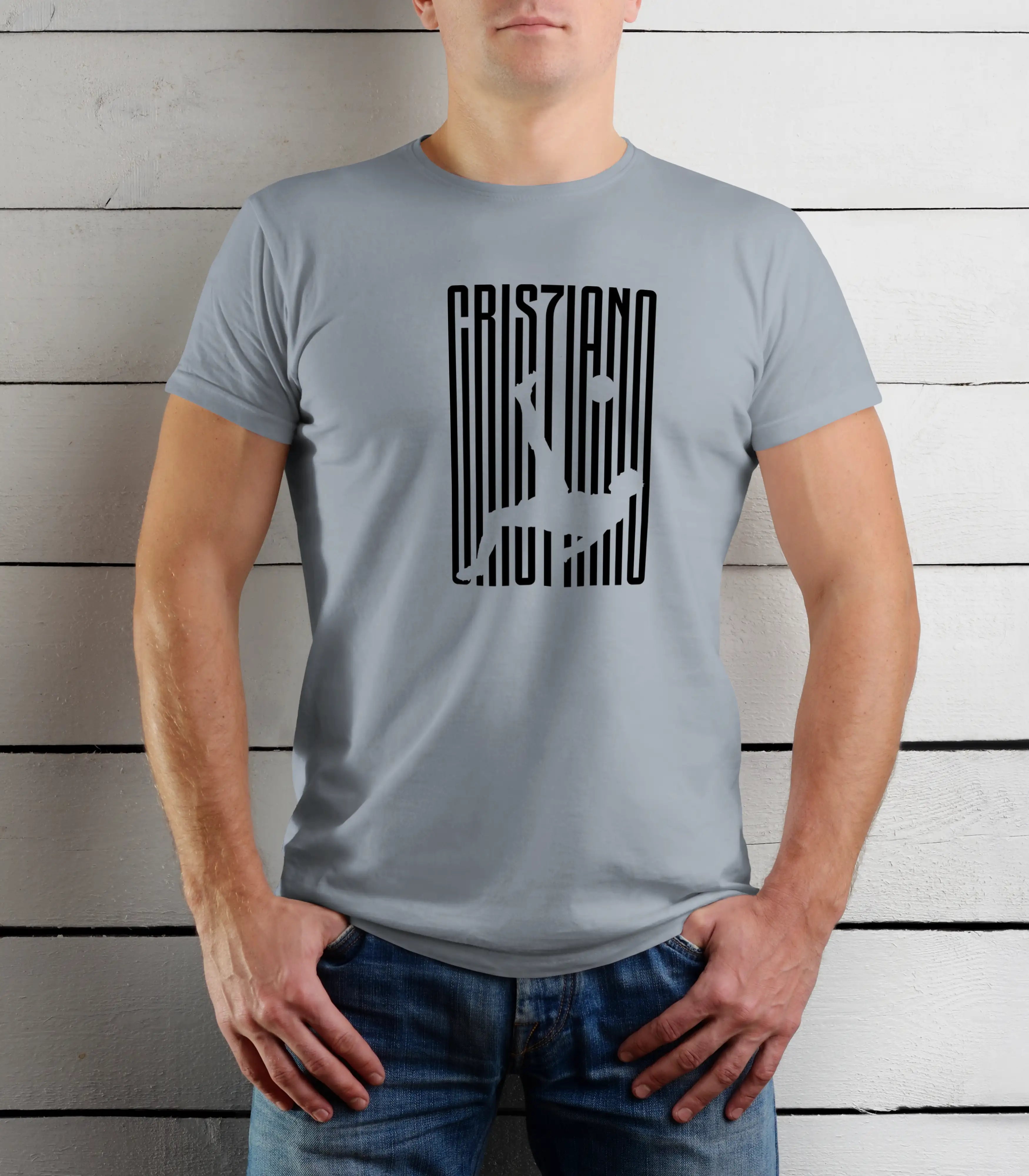 Person wearing a gray t-shirt with black text design against a wooden background