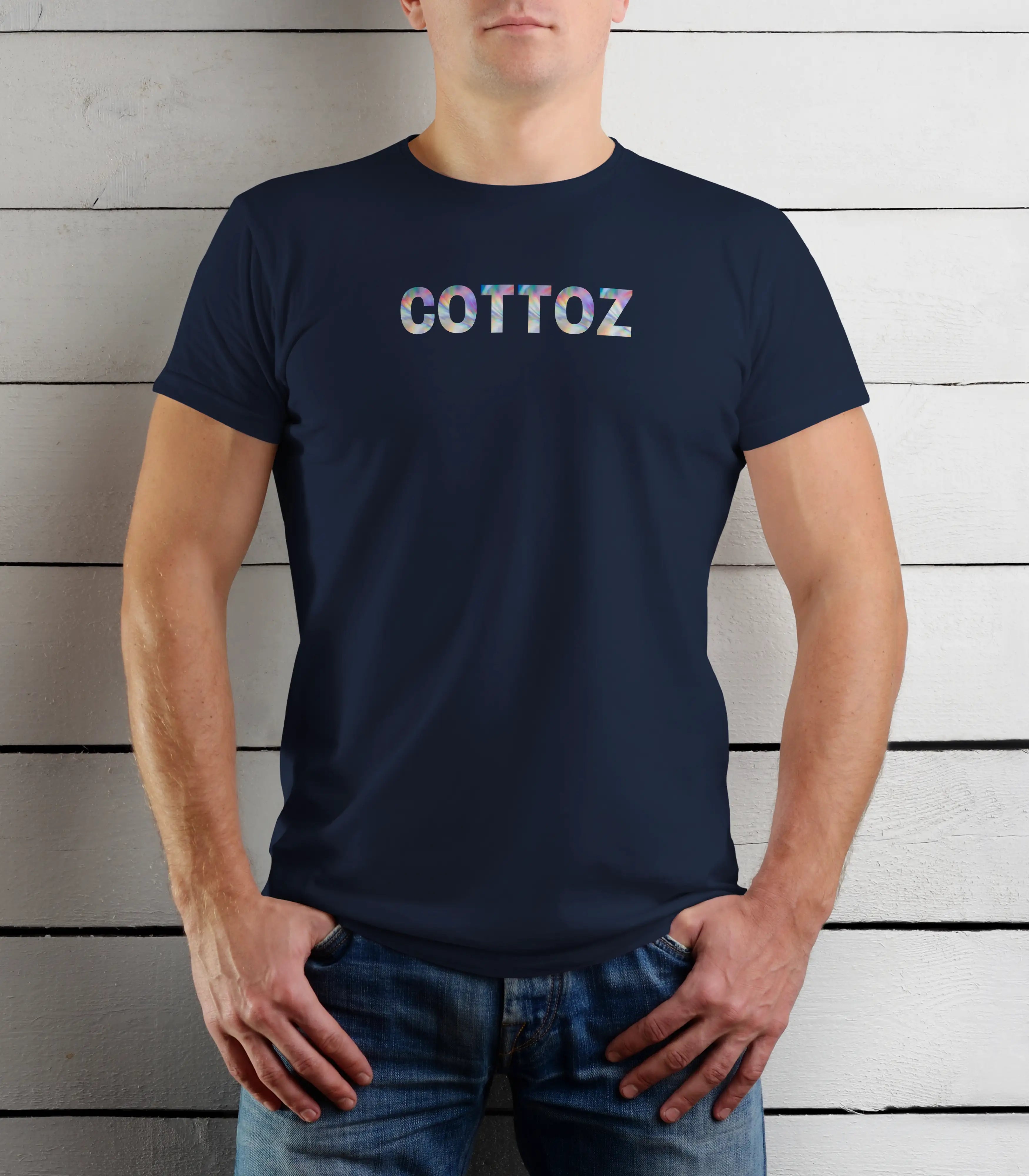 Person wearing a navy blue t-shirt with 'COTTOZ' printed on it against a wooden background
