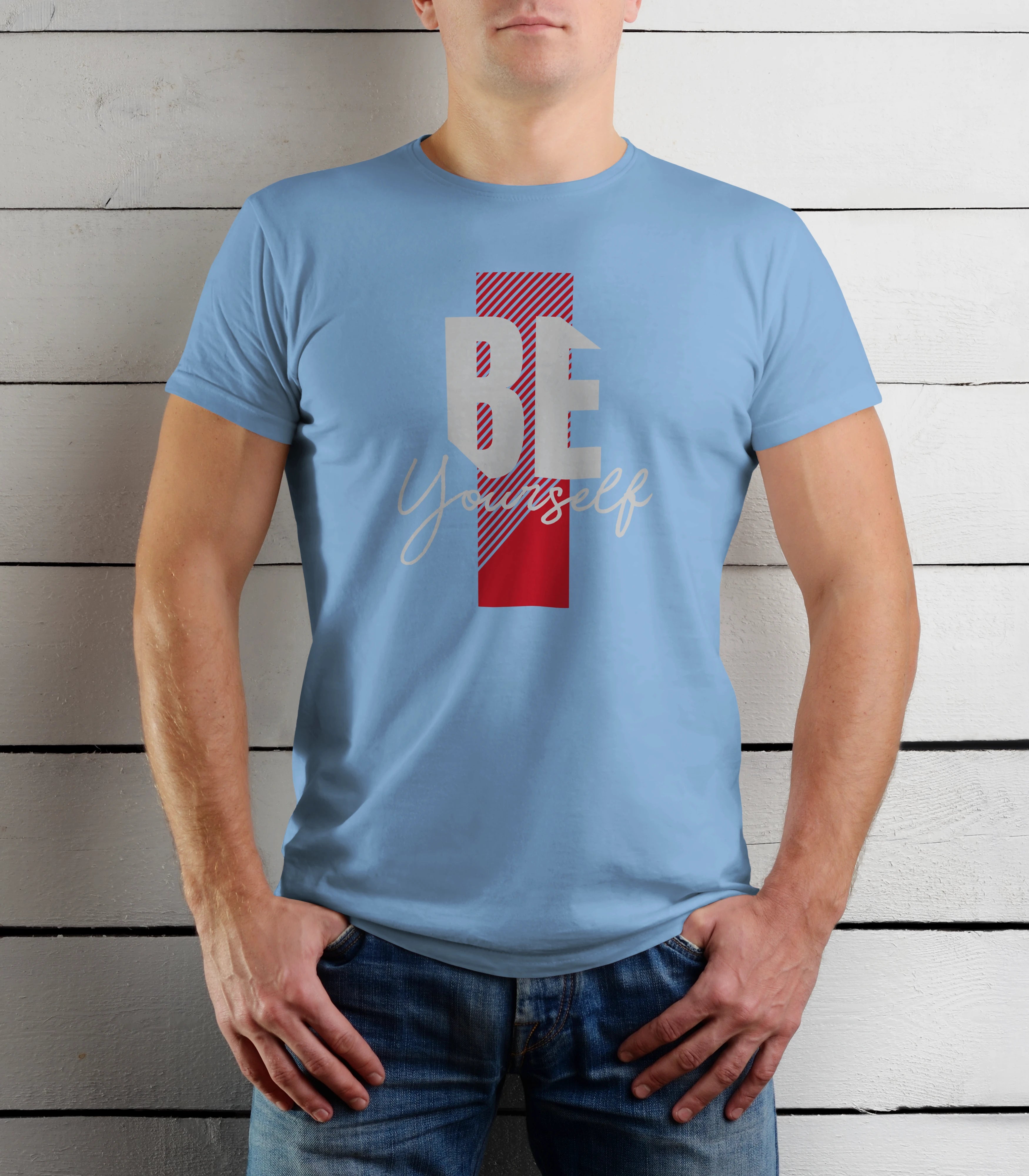 Person wearing a light blue t-shirt with a motivational quote against a wooden background