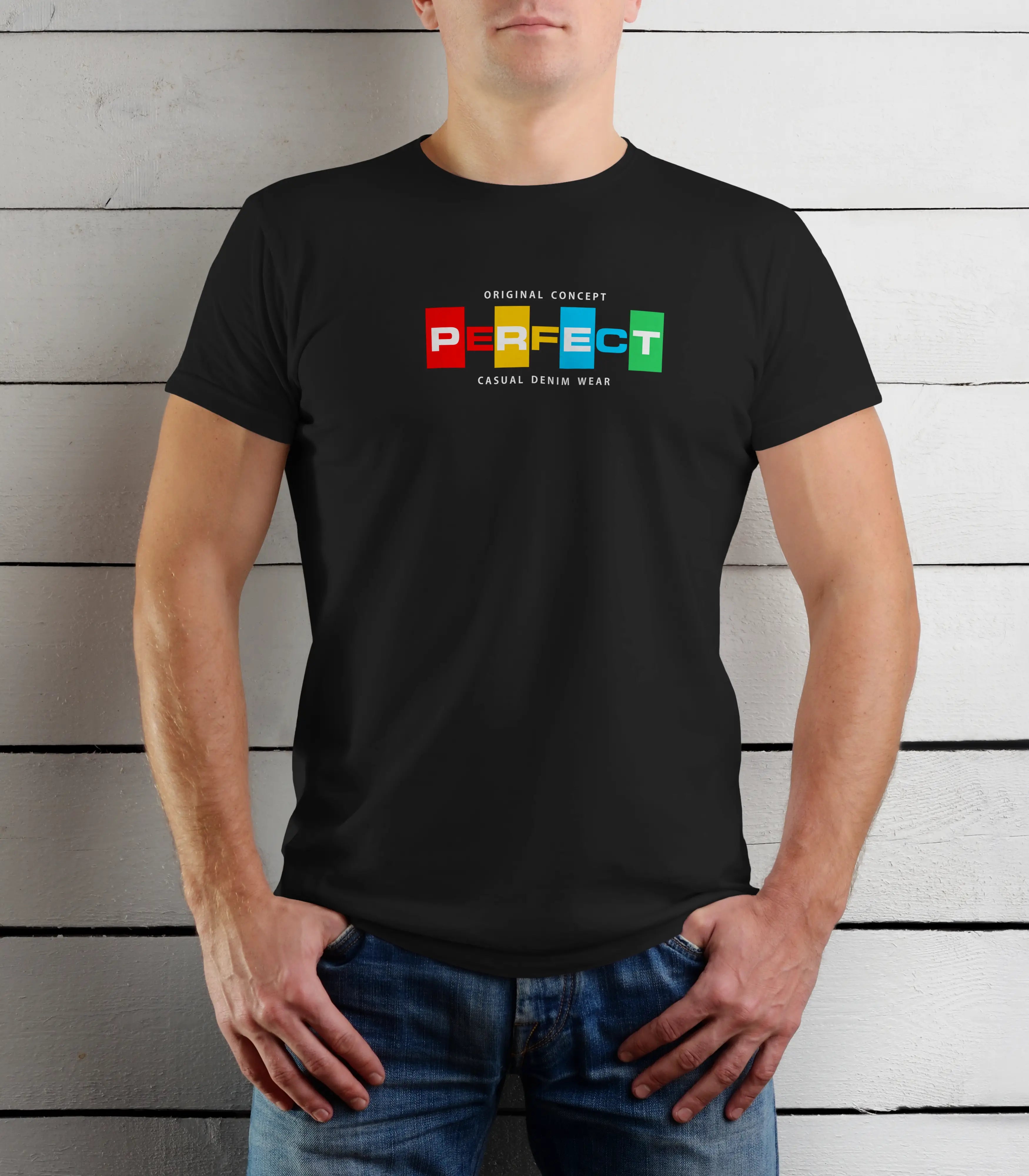 Person wearing a black t-shirt with colorful text design against a wooden background