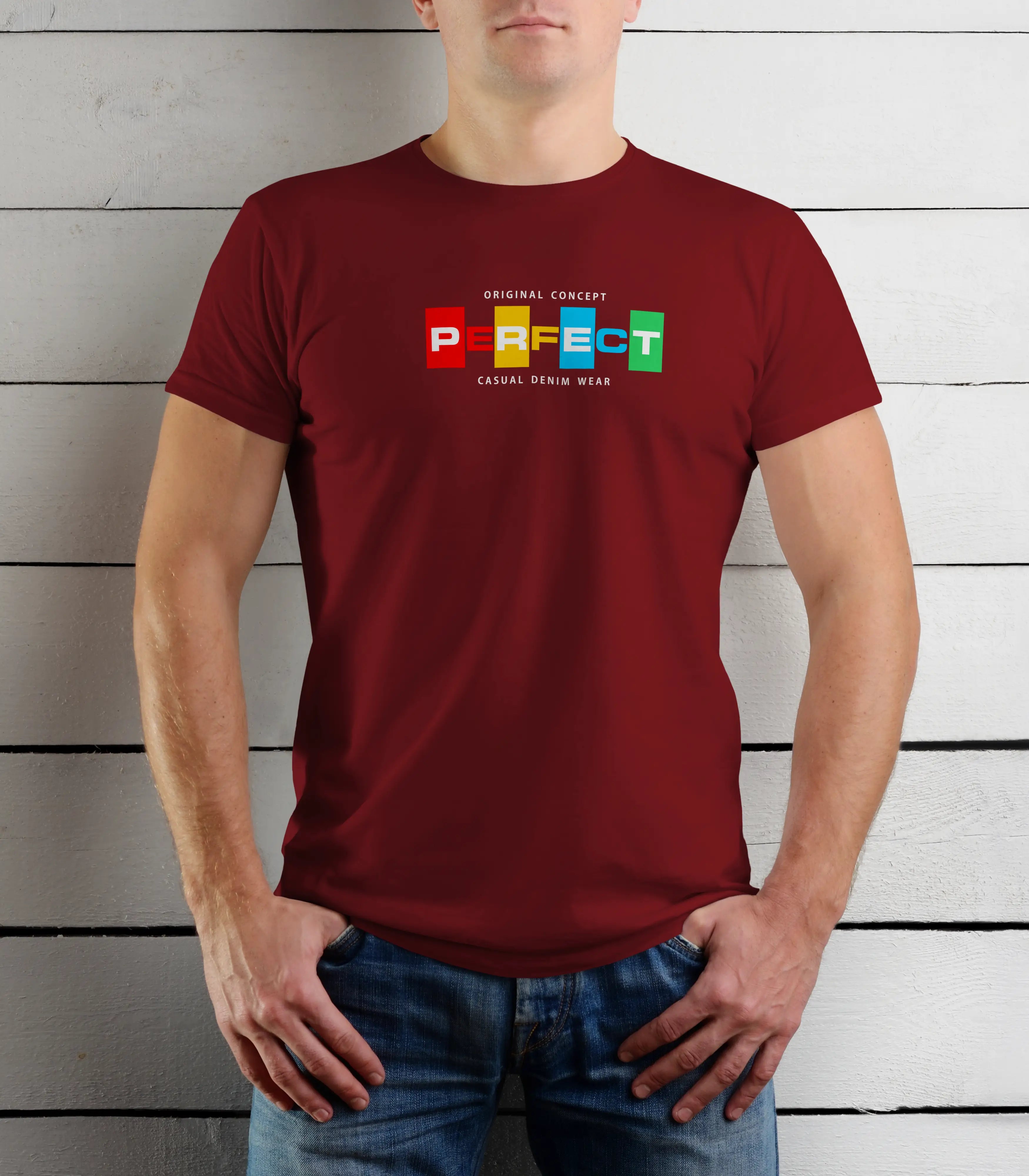 Person wearing a maroon t-shirt with colorful text design against a wooden background