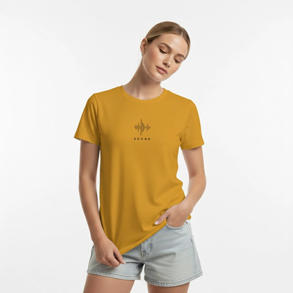 Woman wearing a mustard yellow t-shirt with a black graphic design on a white background