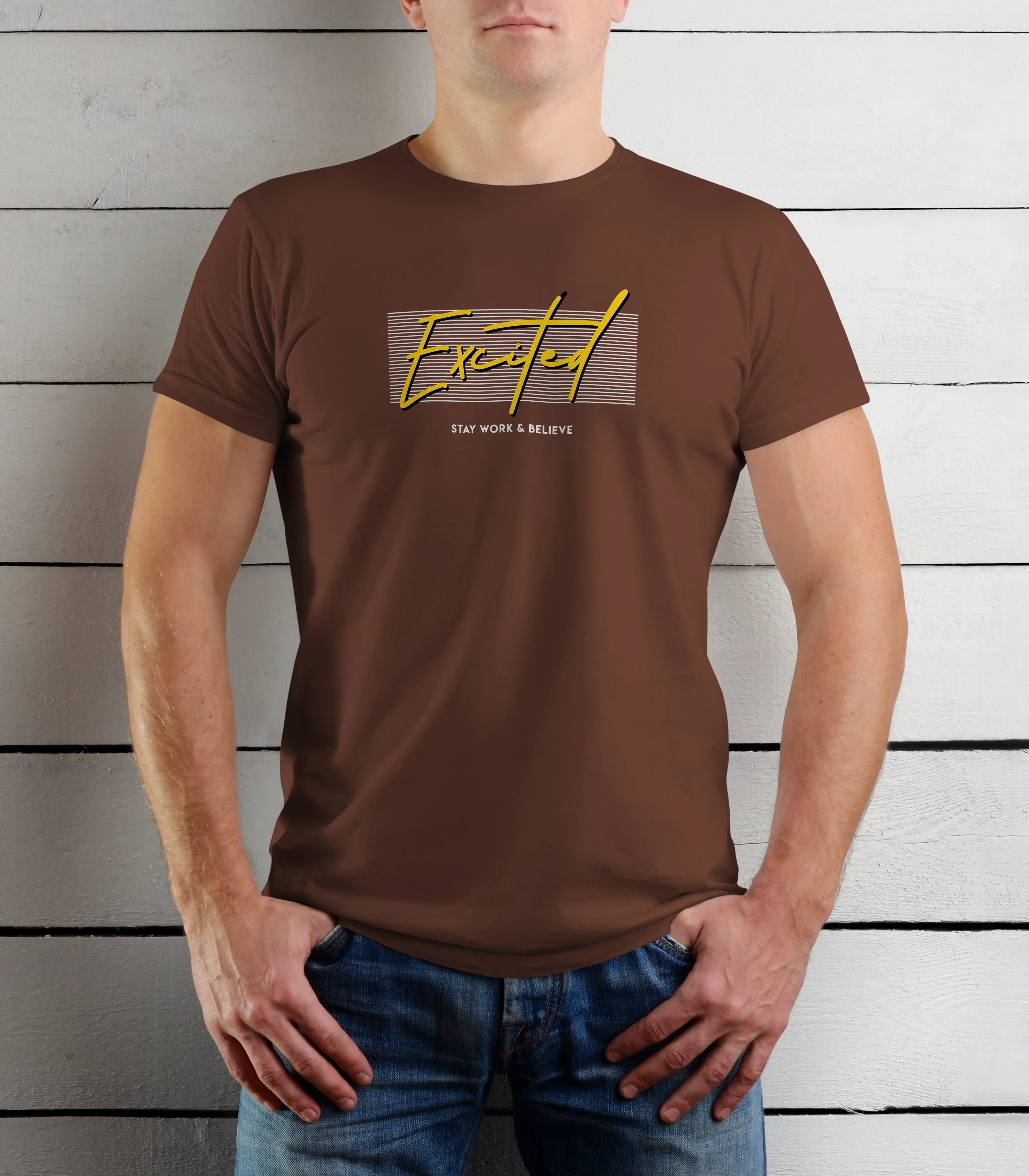 Person wearing a brown t-shirt with yellow text against a wooden background
