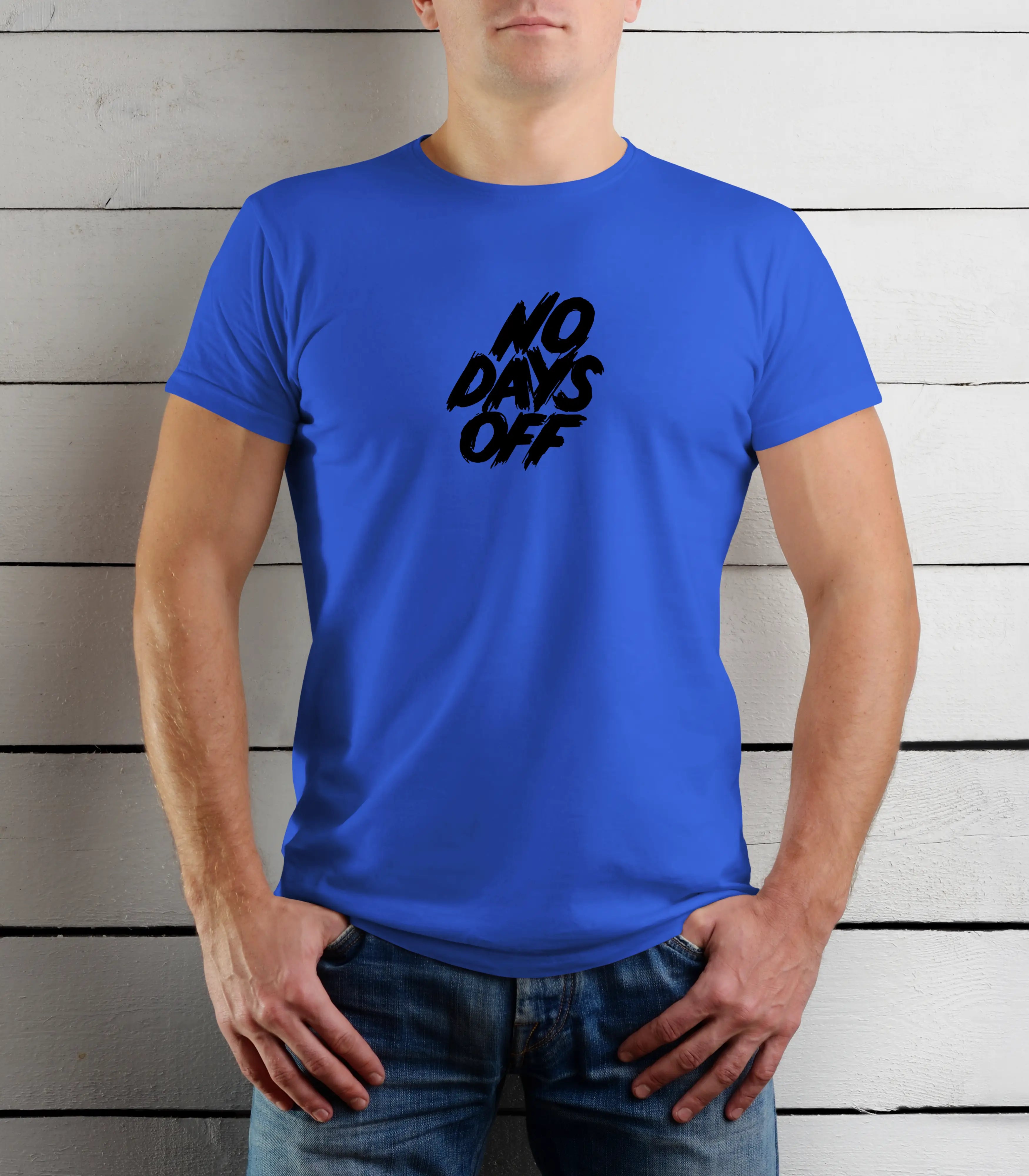 Person wearing a blue t-shirt with 'NO DAYS OFF' text against a wooden background