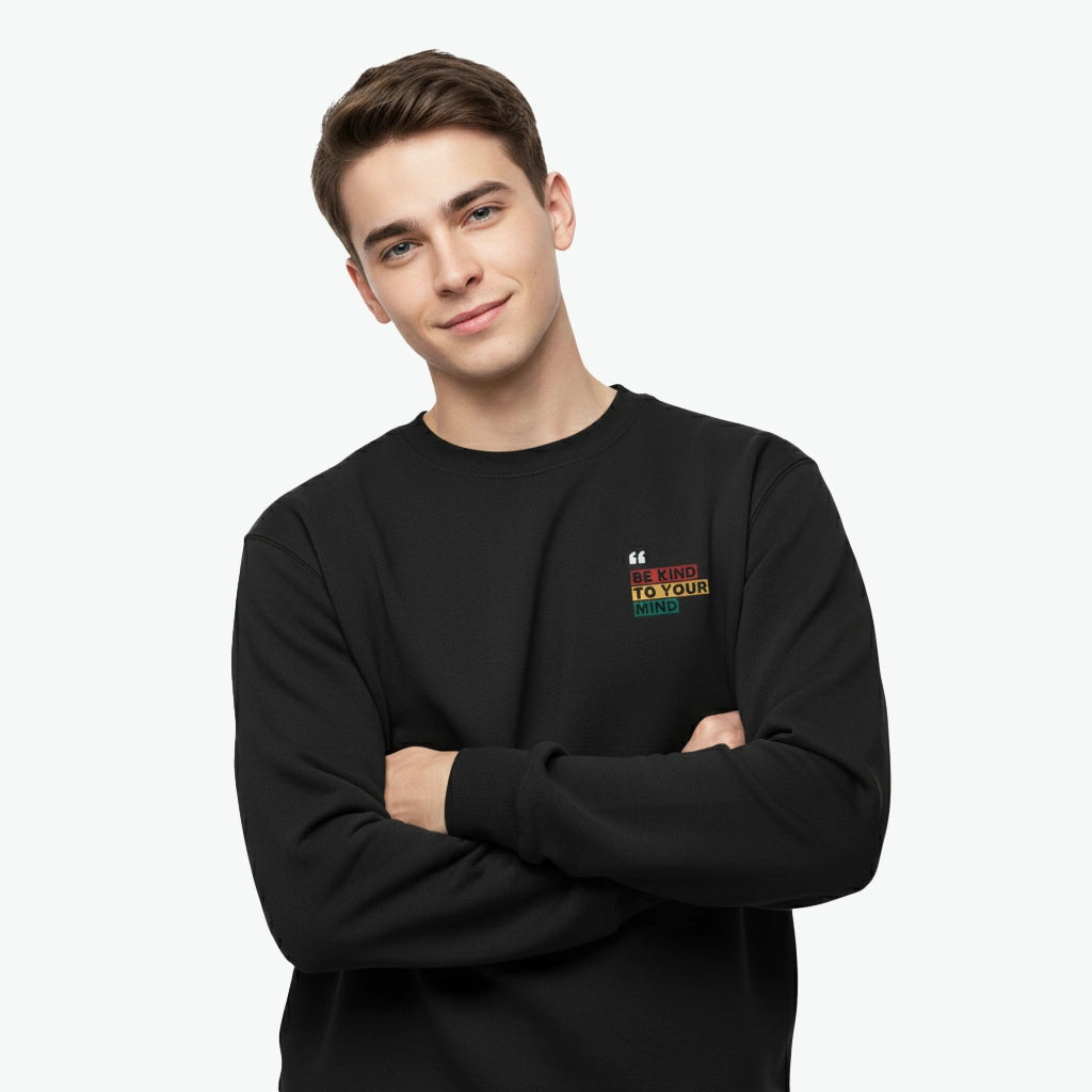 Person wearing a black sweatshirt with a colorful logo on a white background