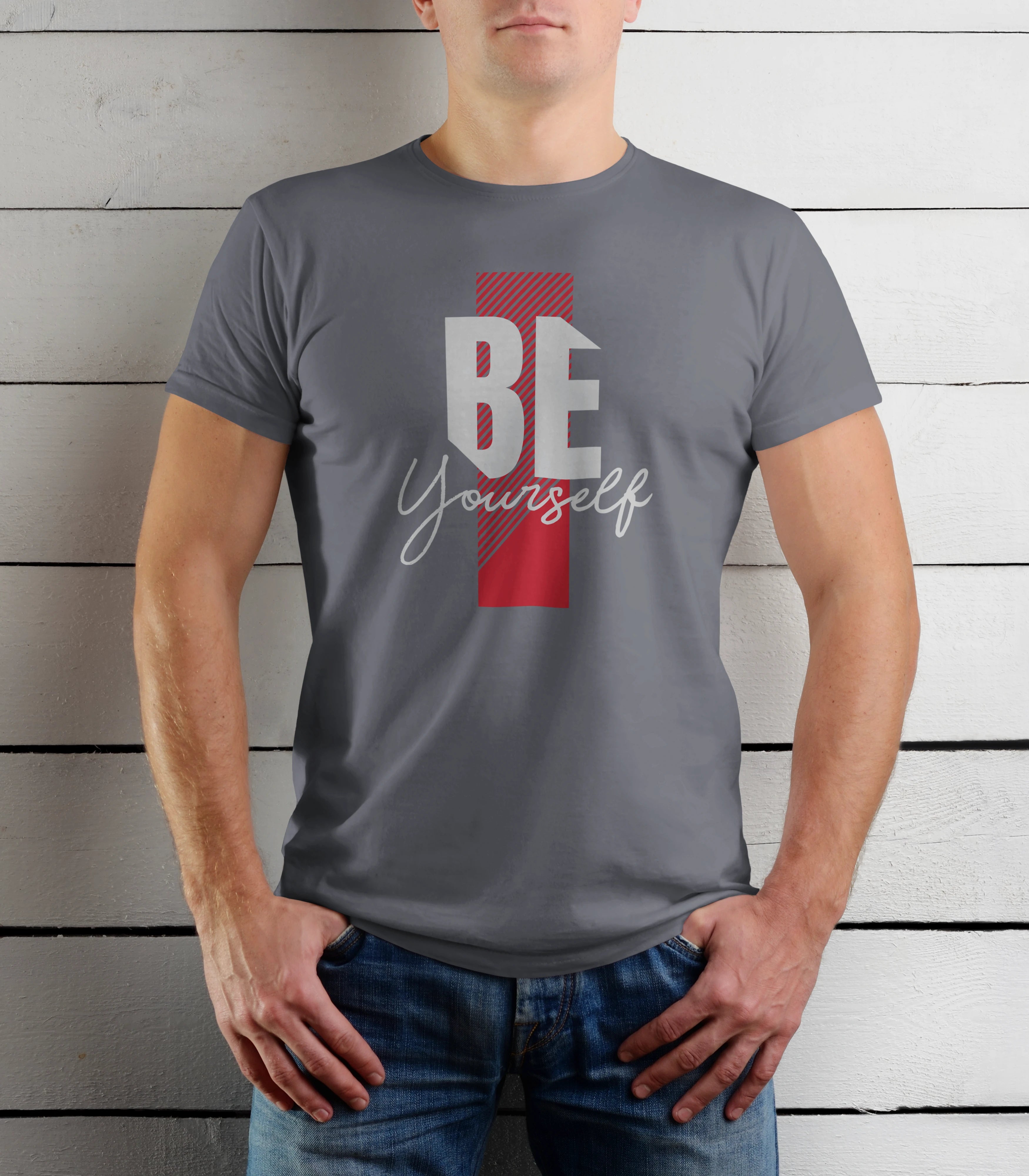 Person wearing a gray t-shirt with 'BE Yourself' text design on a wooden background