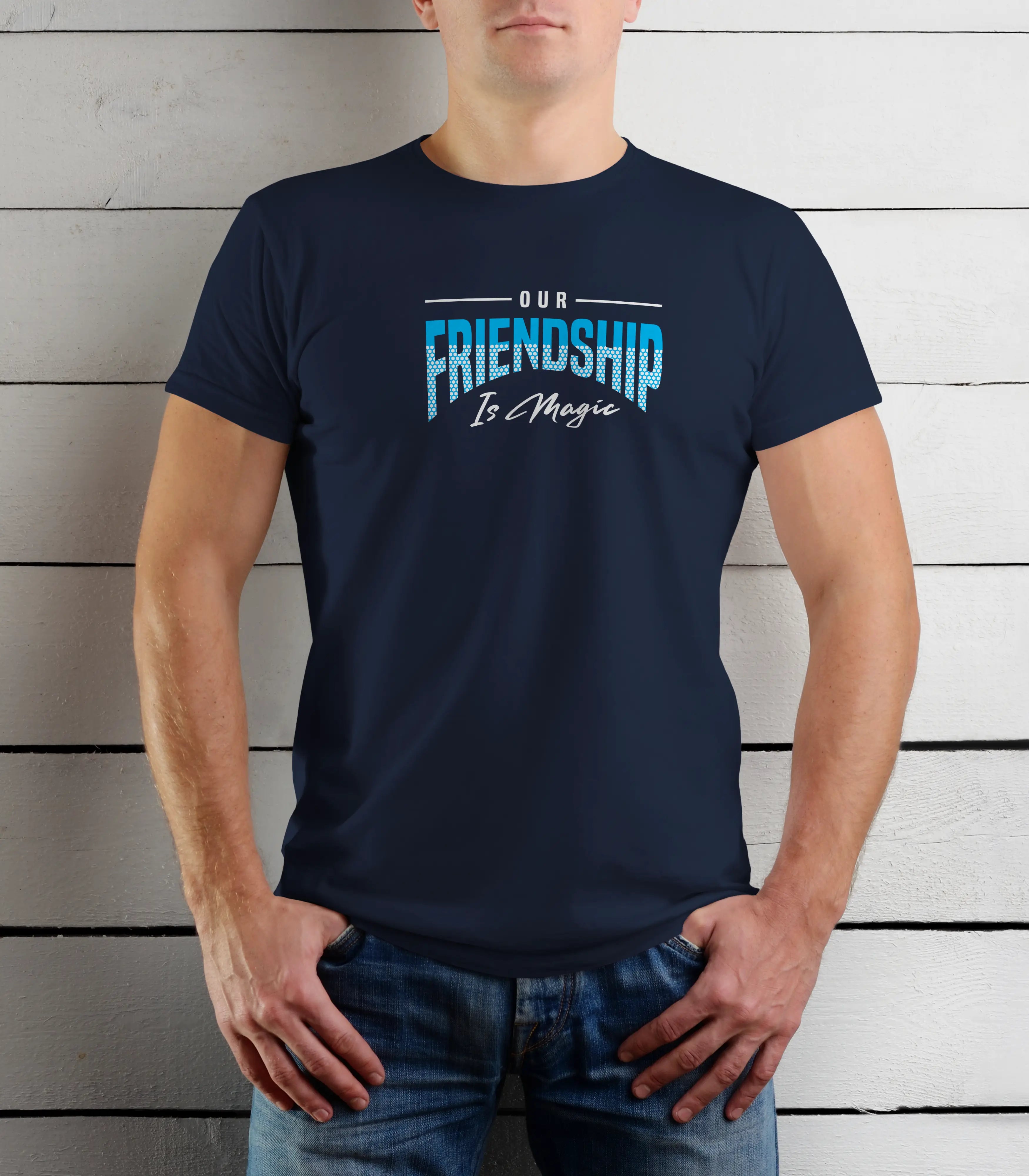 Person wearing a navy blue t-shirt with 'Our Friendship Is Magic' text against a wooden background