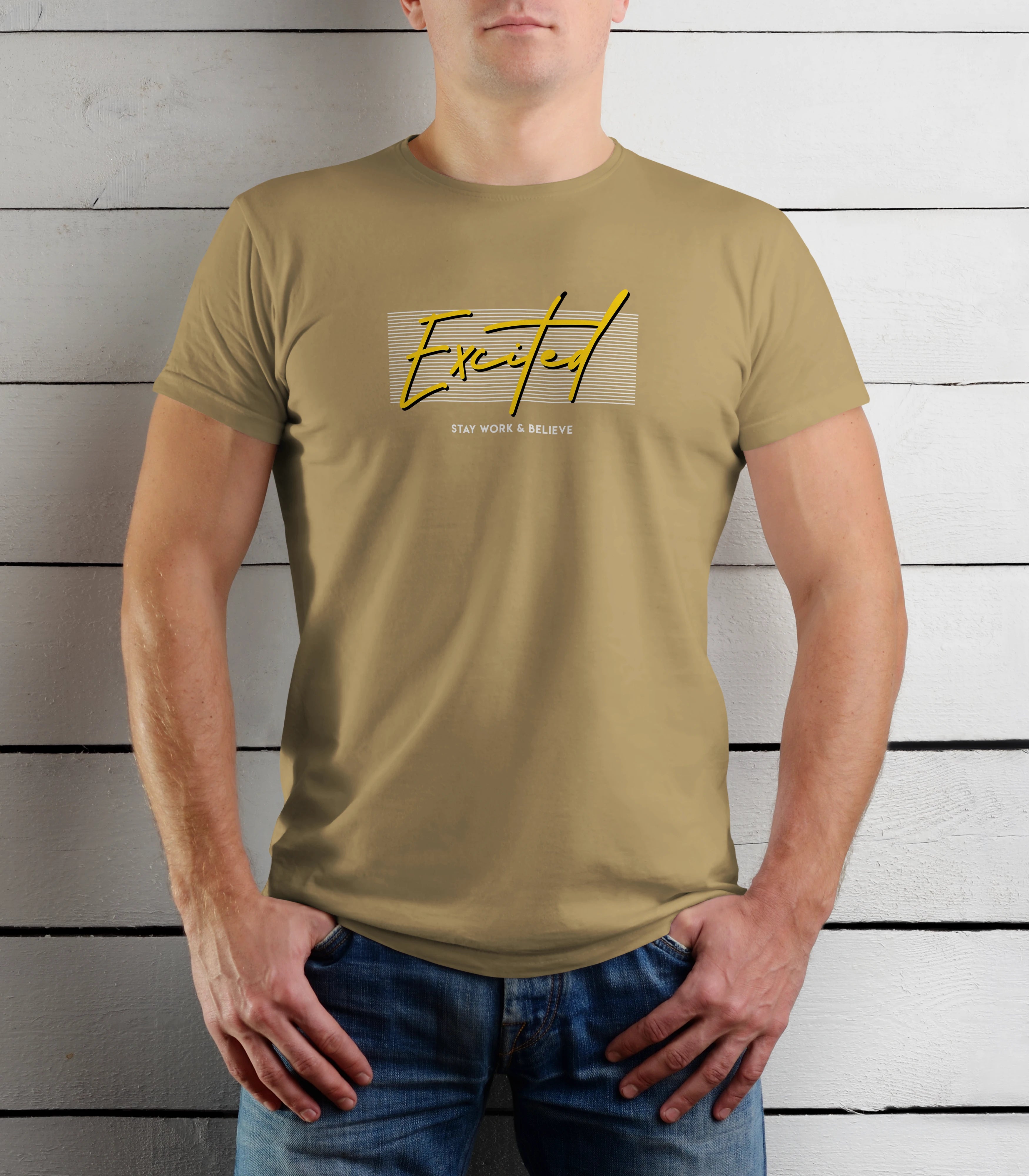 Person wearing a khaki t-shirt with a graphic design against a wooden background