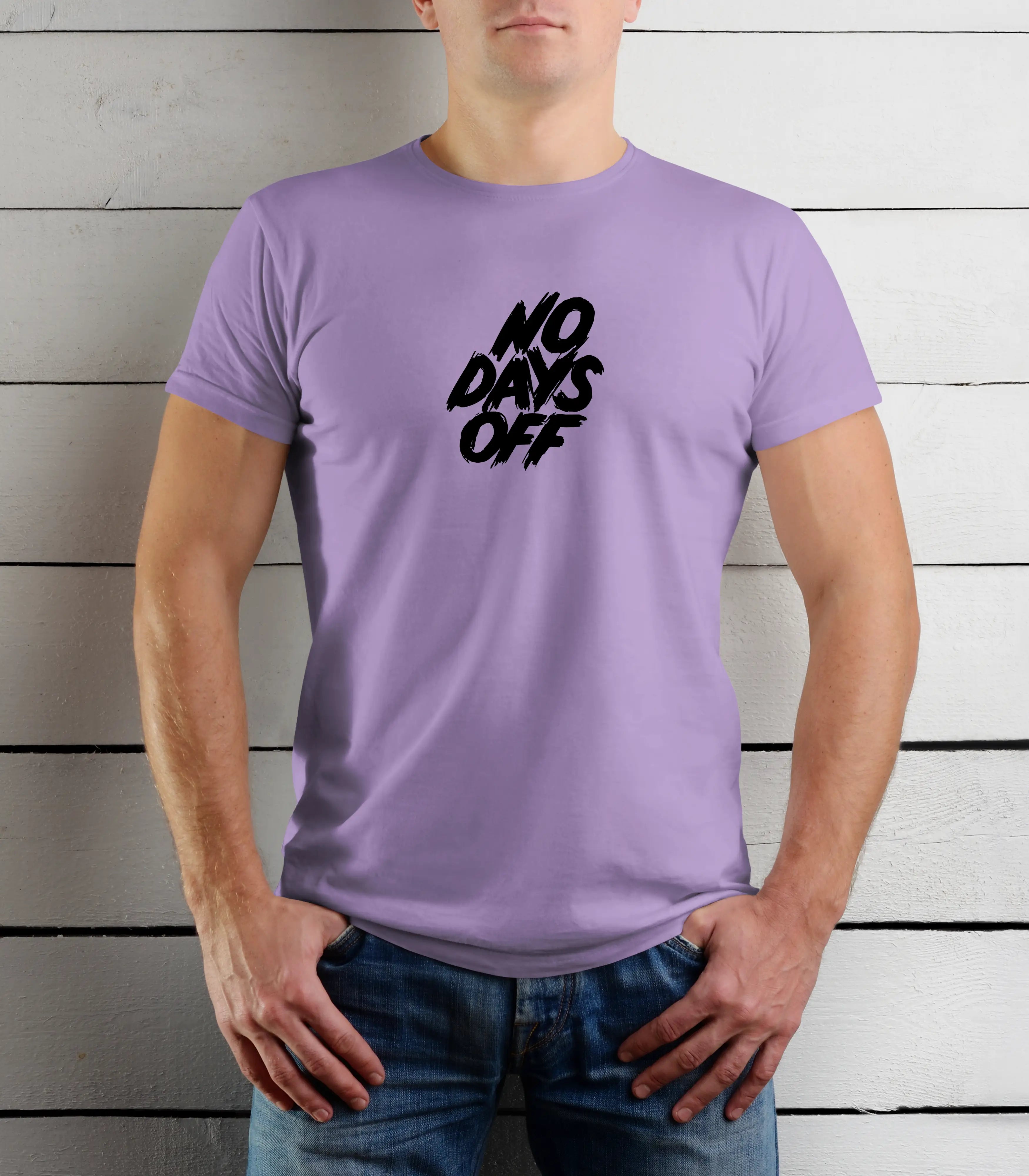Person wearing a purple t-shirt with 'No Days Off' text against a wooden background
