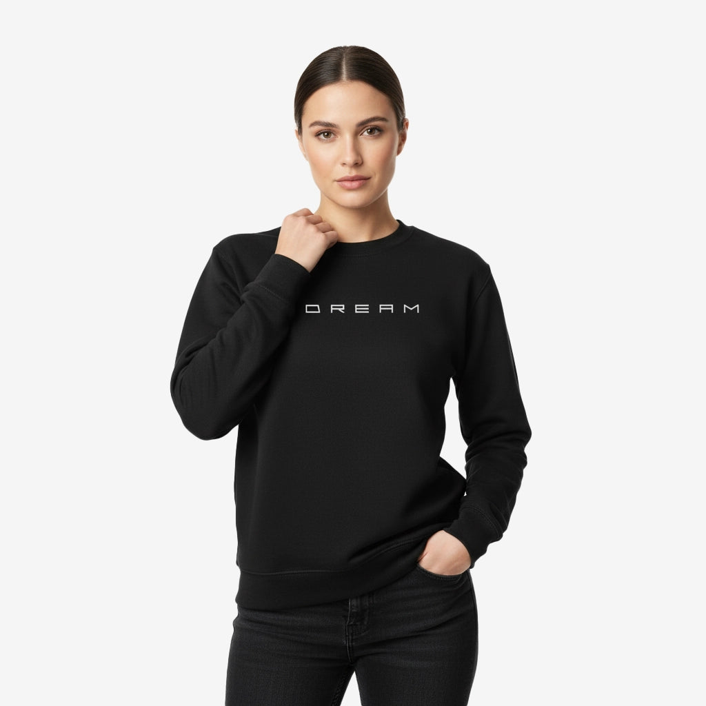 Woman wearing a black sweatshirt with 'DREAM' text on a white background