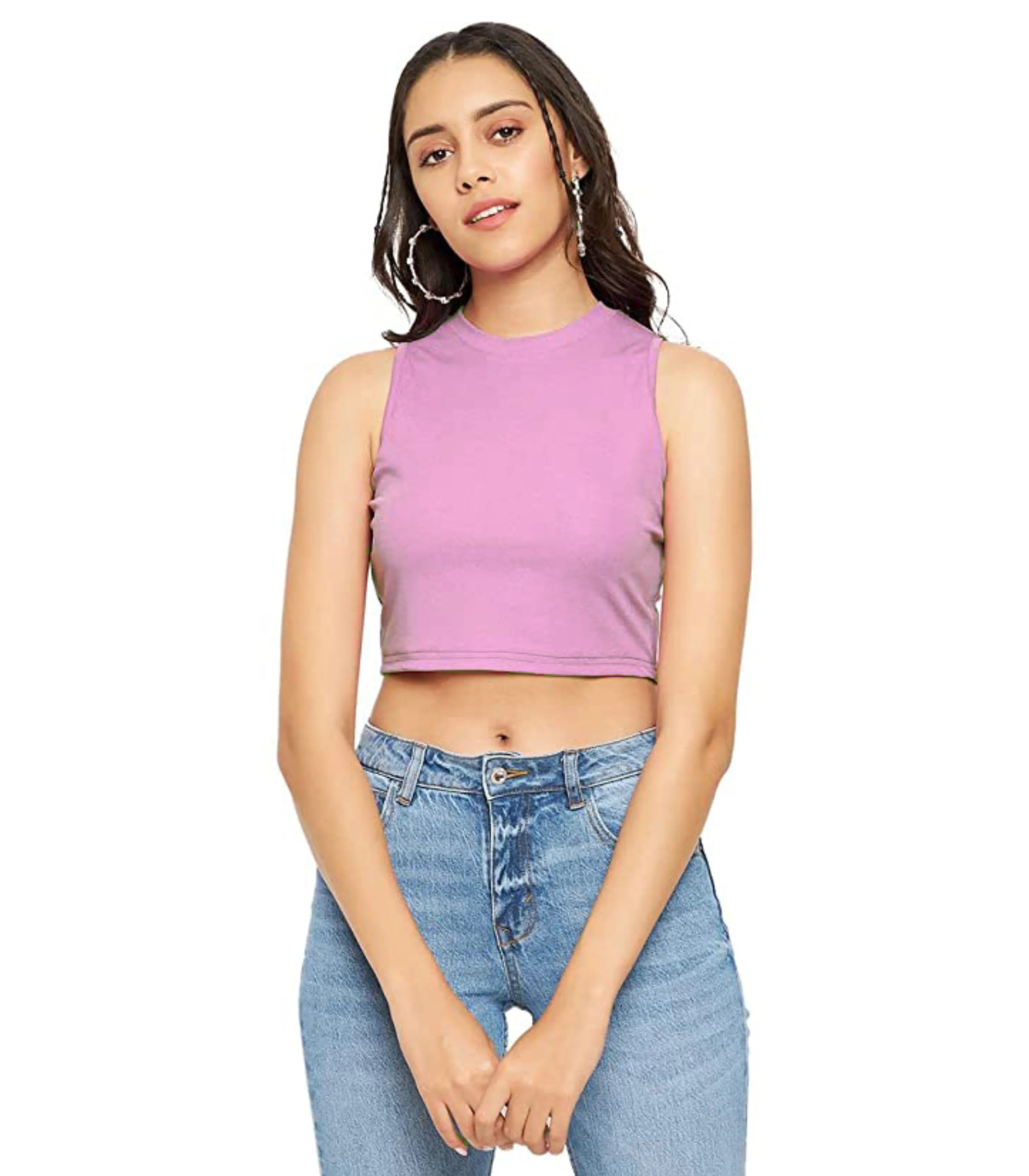 Woman wearing a purple crop top and blue jeans on a white background