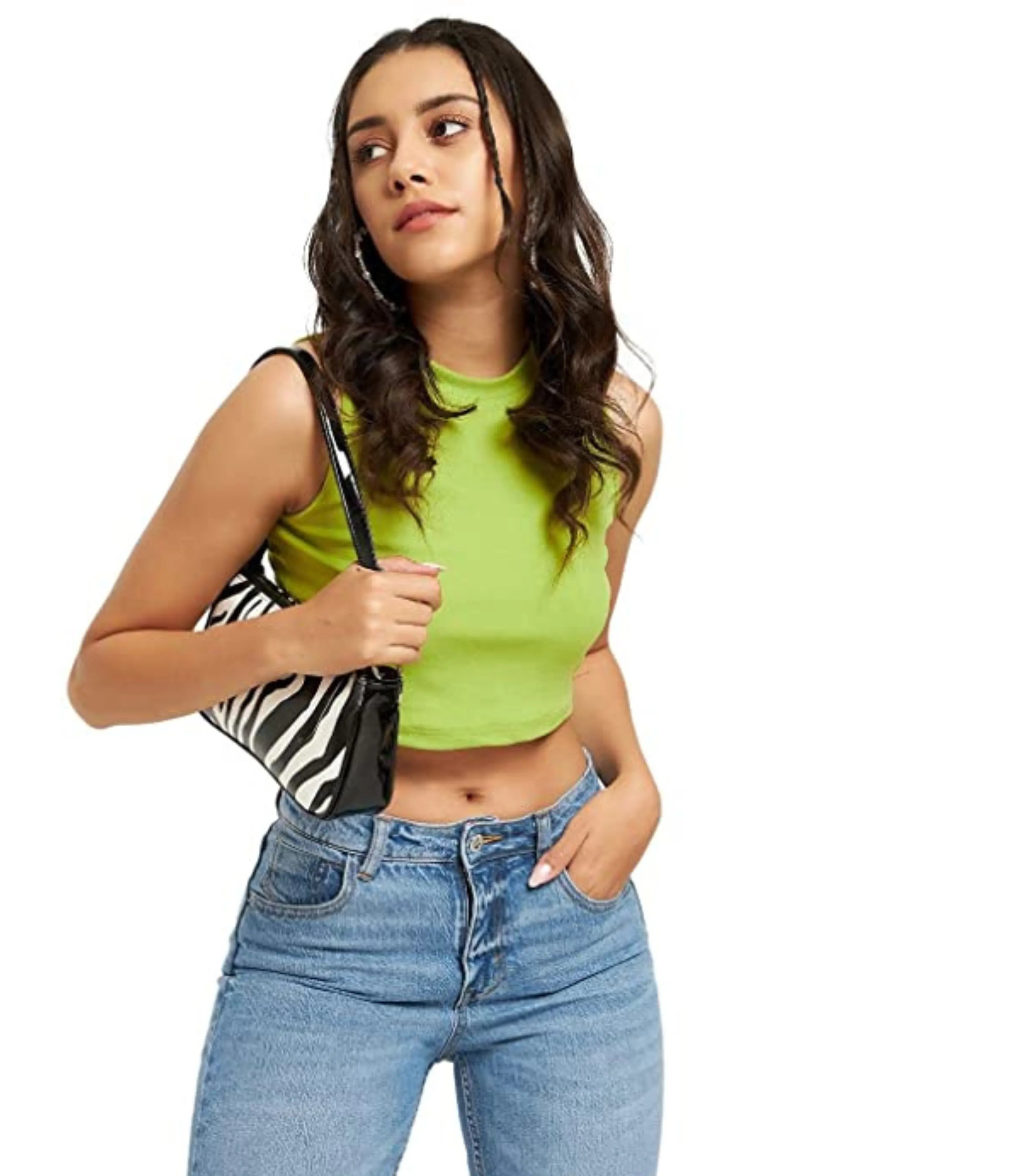 Woman wearing a green sleeveless top and blue jeans holding a zebra pattern bag on a white background