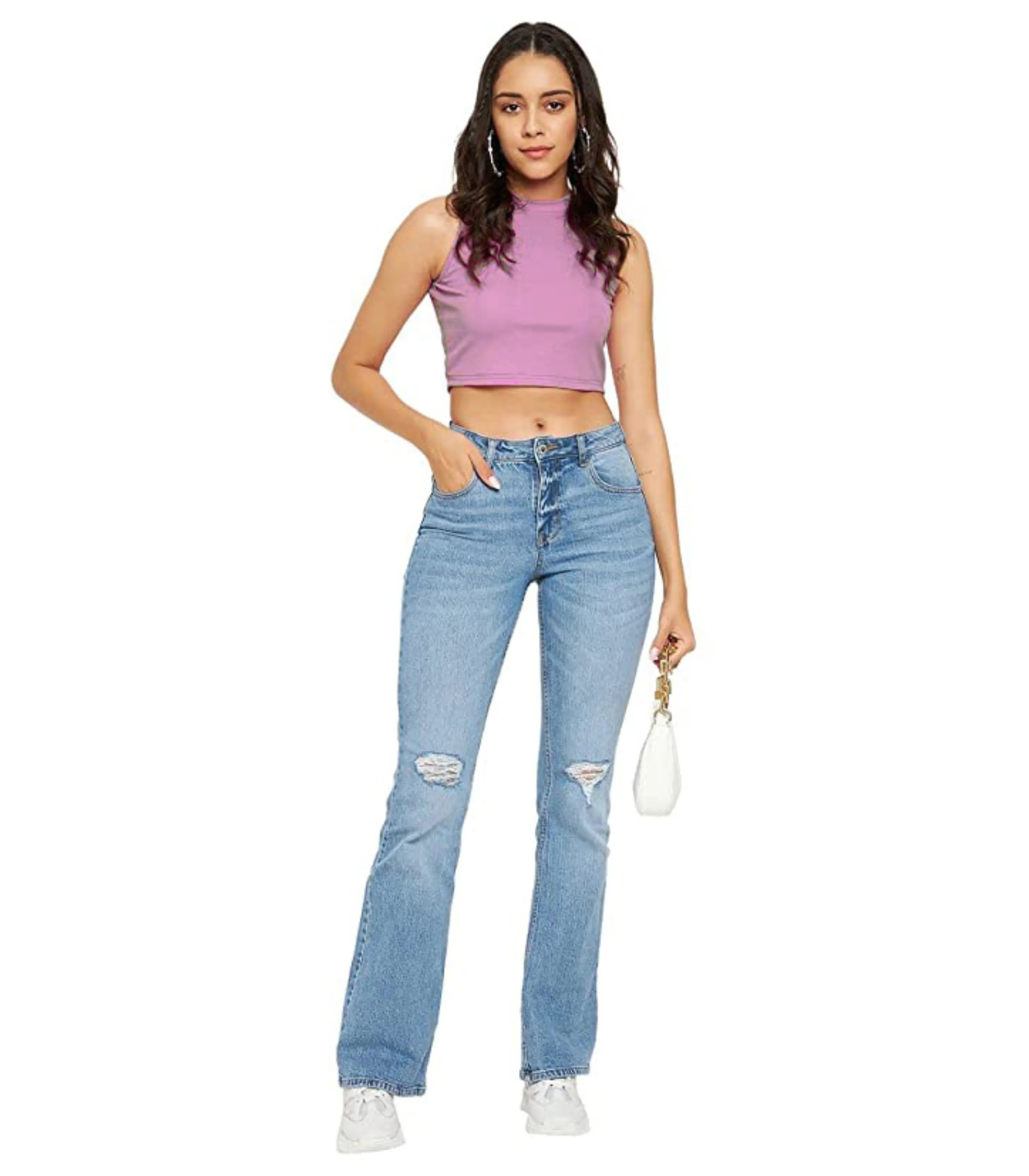 Woman wearing a pink sleeveless top and light blue jeans on a white background