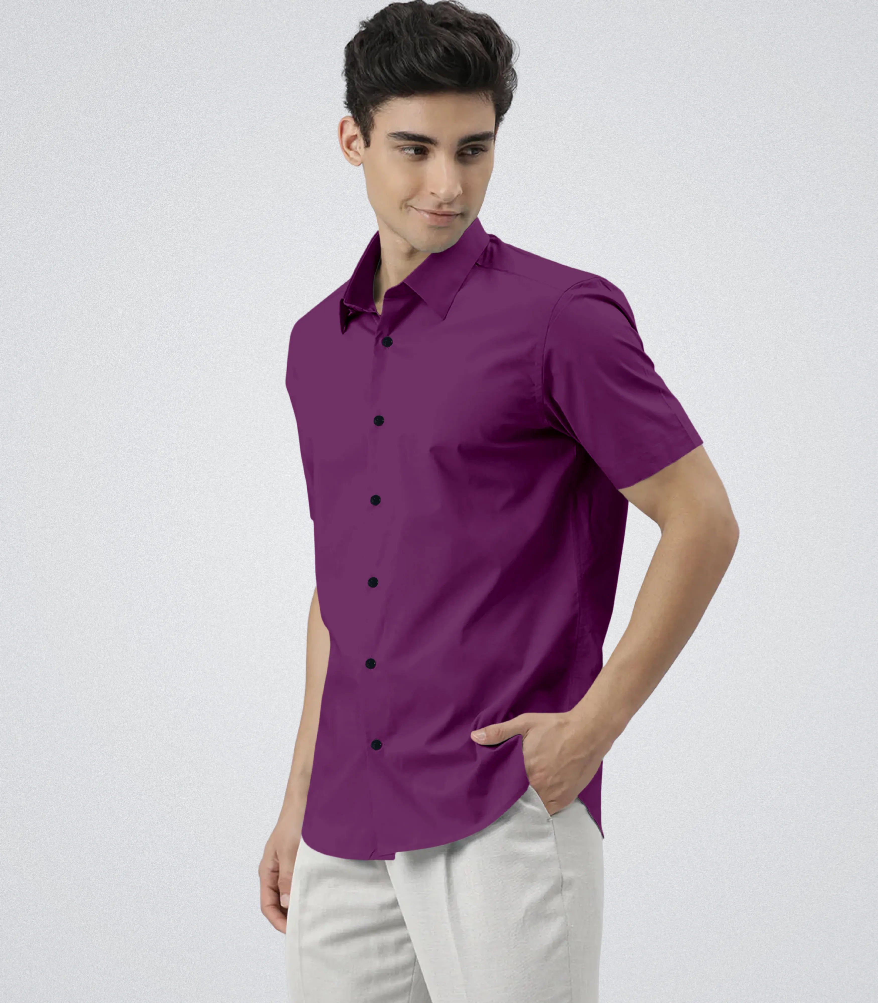 Man wearing a purple shirt and white pants on a light gray background
