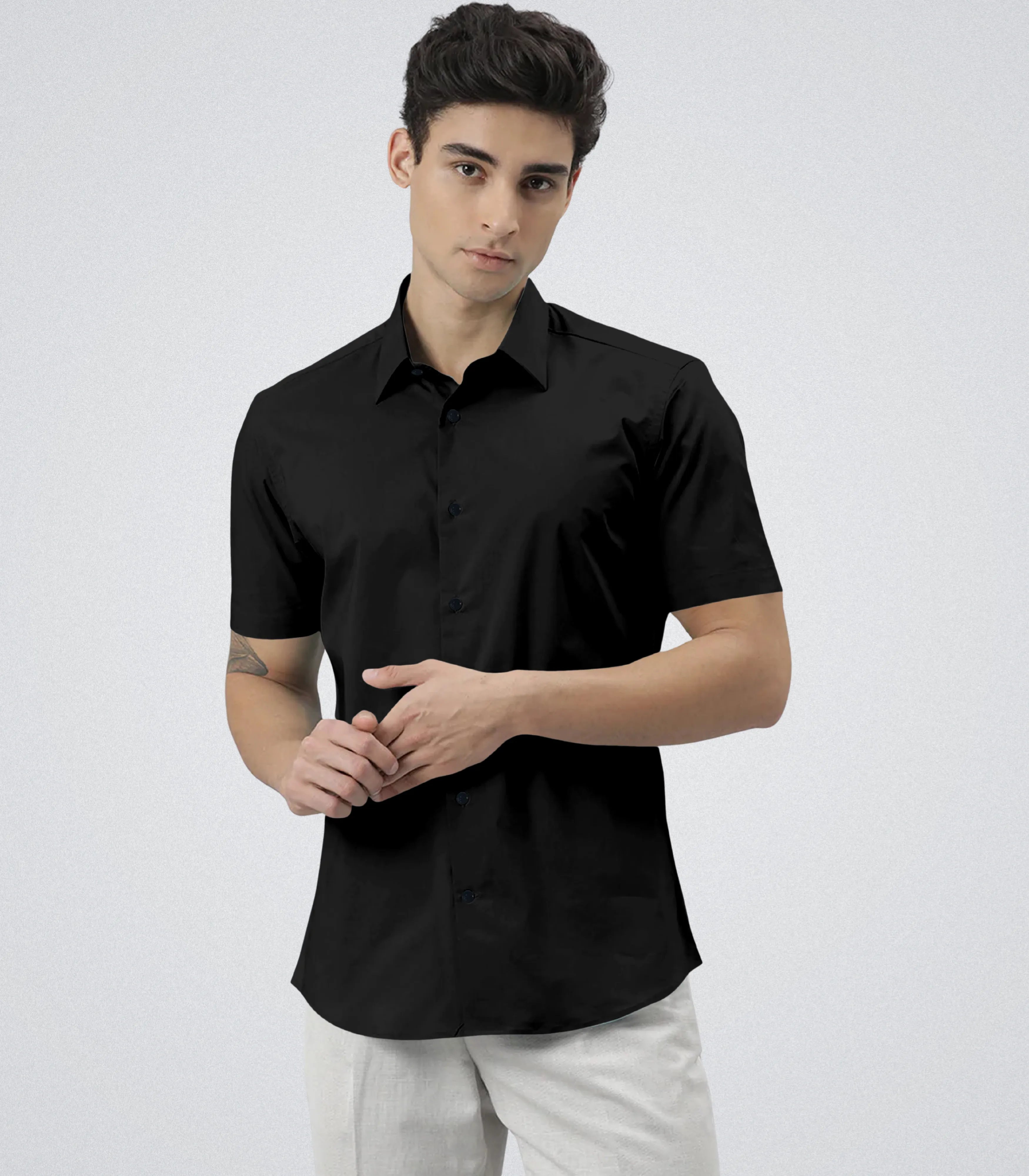 Man wearing a black short-sleeve shirt on a white background