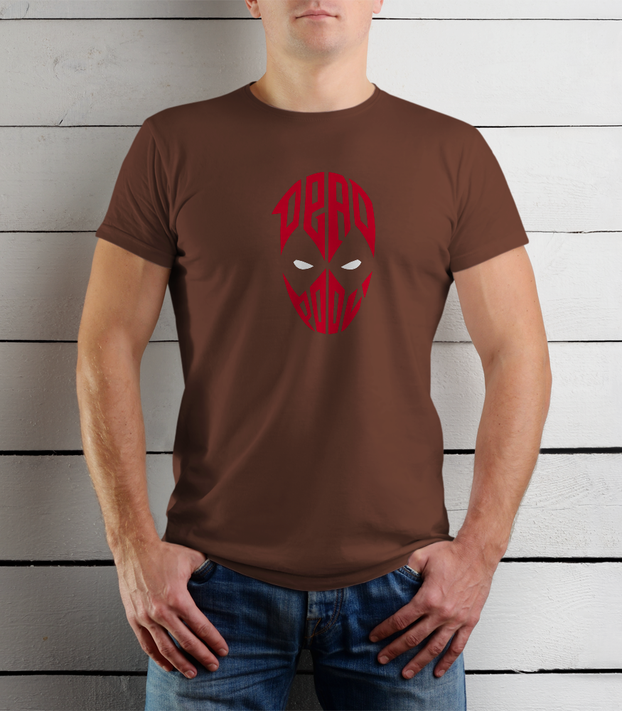 Person wearing a brown t-shirt with a red graphic design against a wooden background