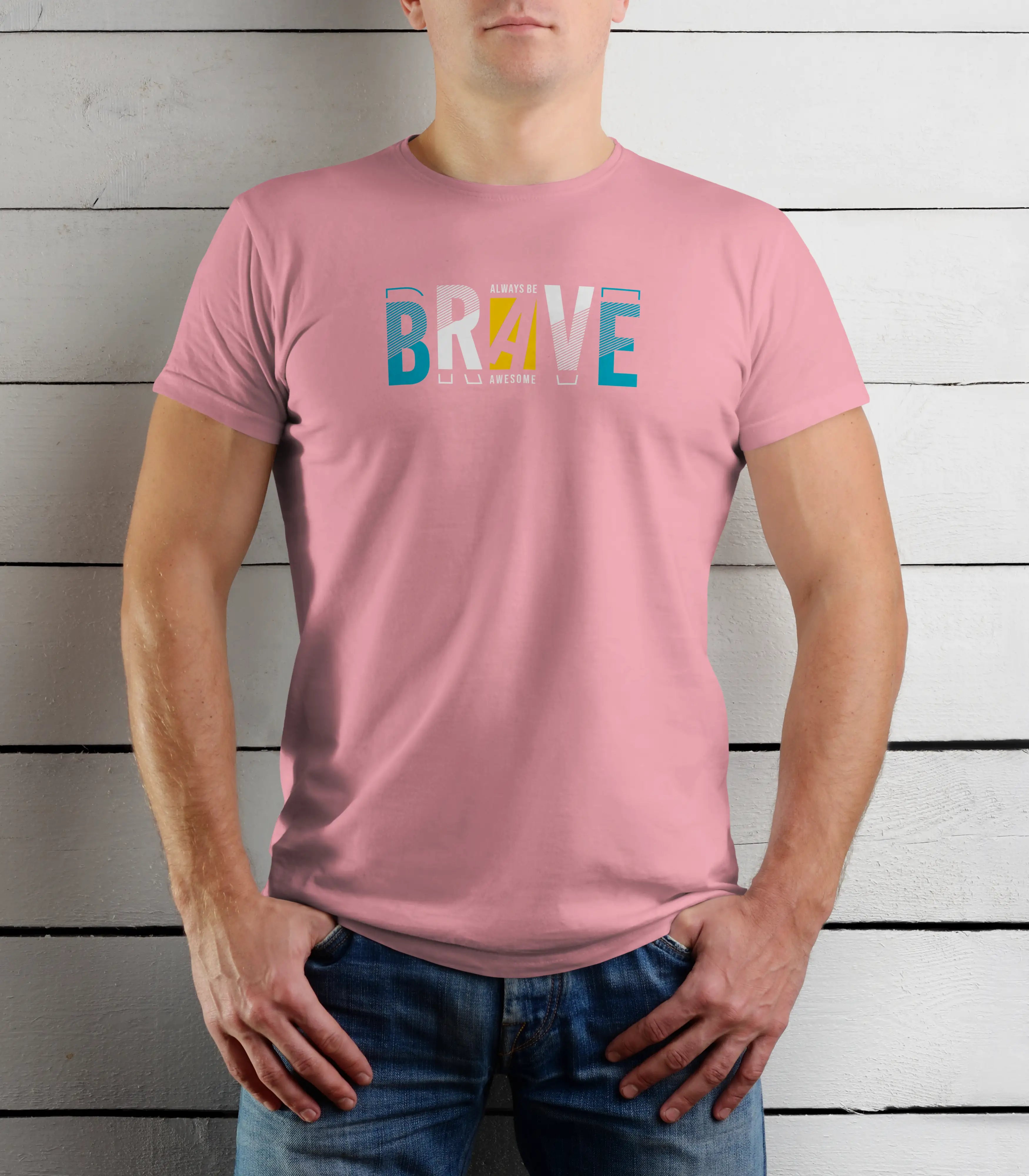 Person wearing a pink t-shirt with 'BRAVE' printed on it against a wooden background