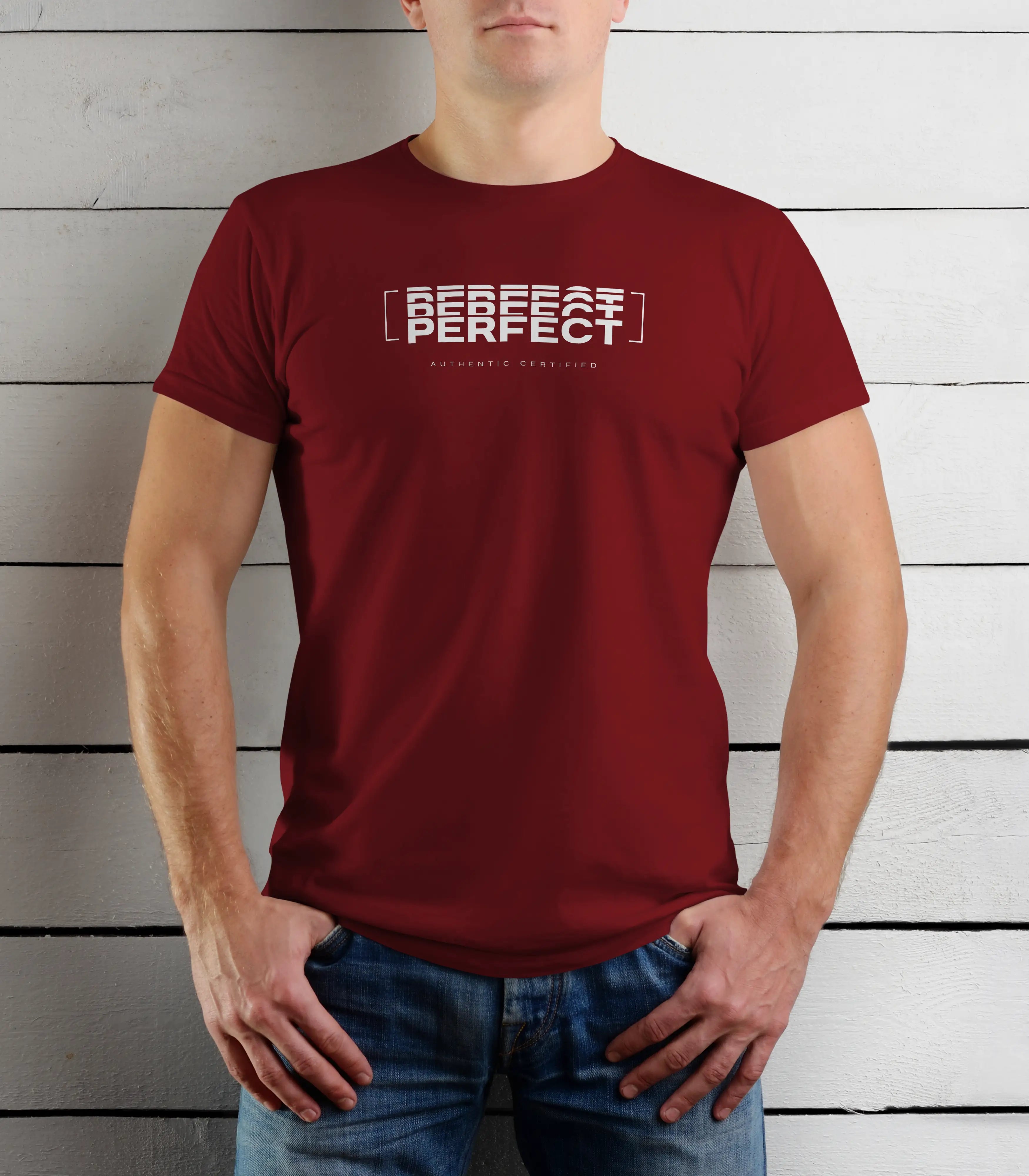 Person wearing a maroon t-shirt with text against a wooden background