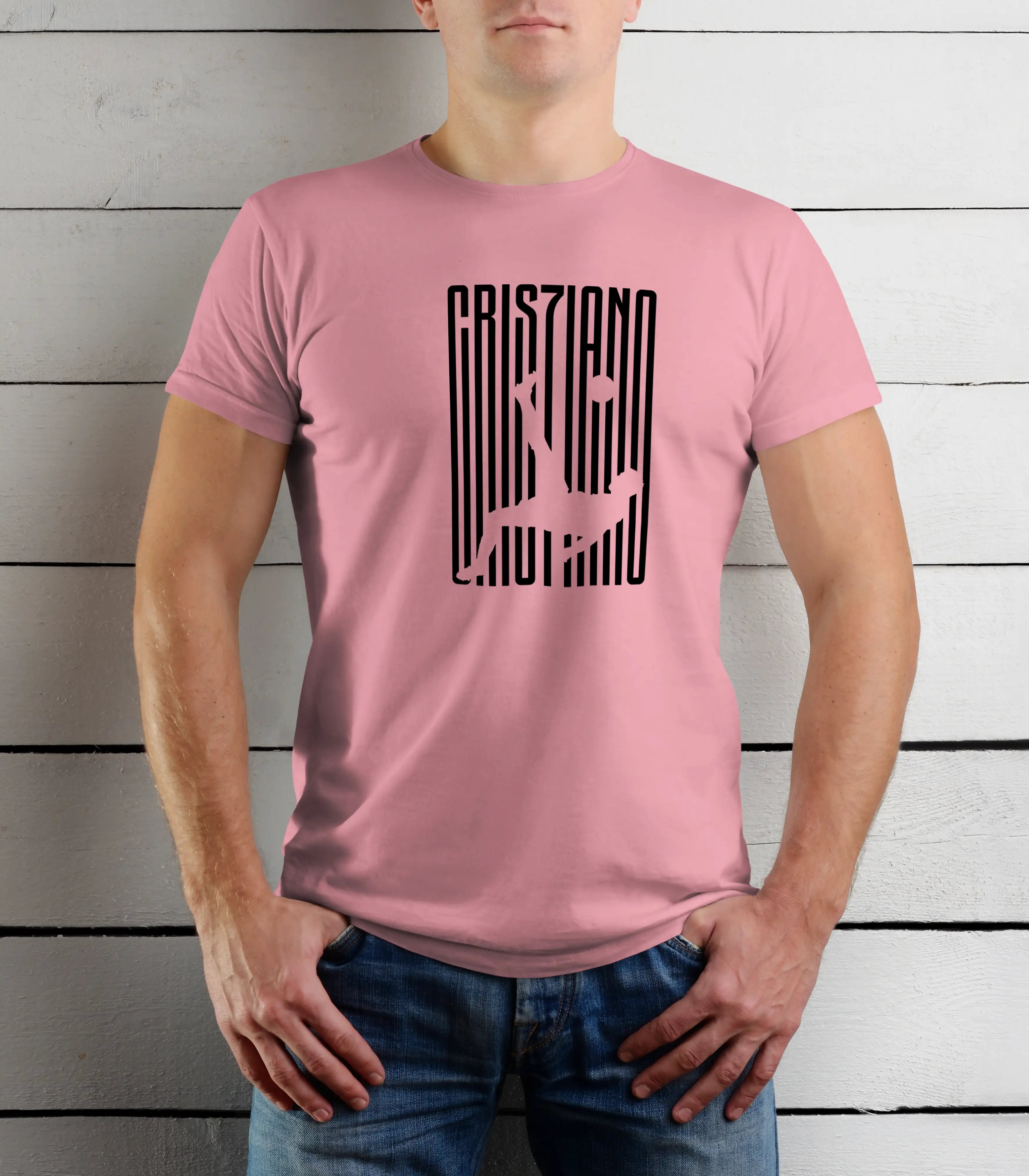 Person wearing a pink t-shirt with black graphic design against a wooden background