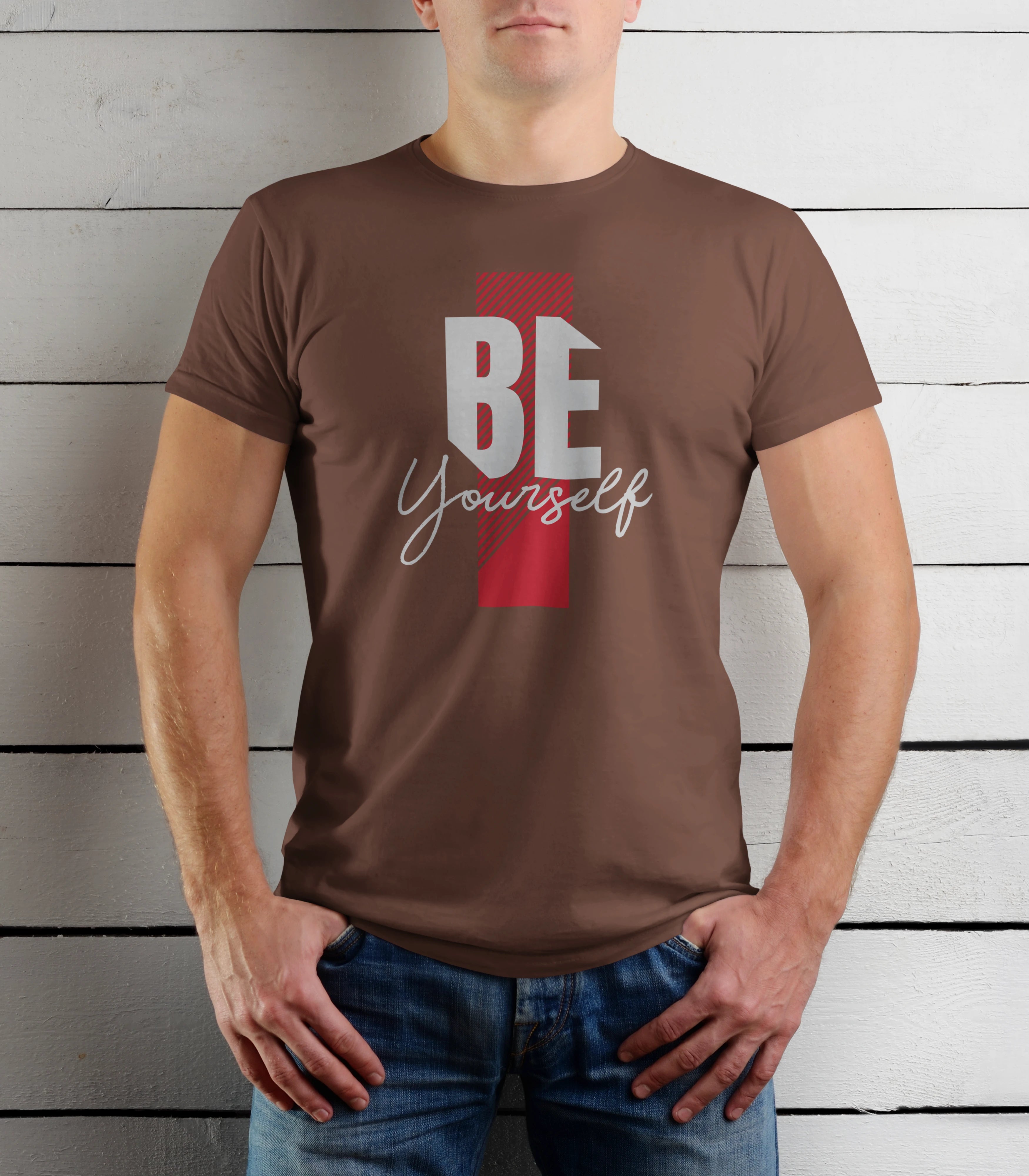 Person wearing a brown t-shirt with 'BE Yourself' text against a wooden background