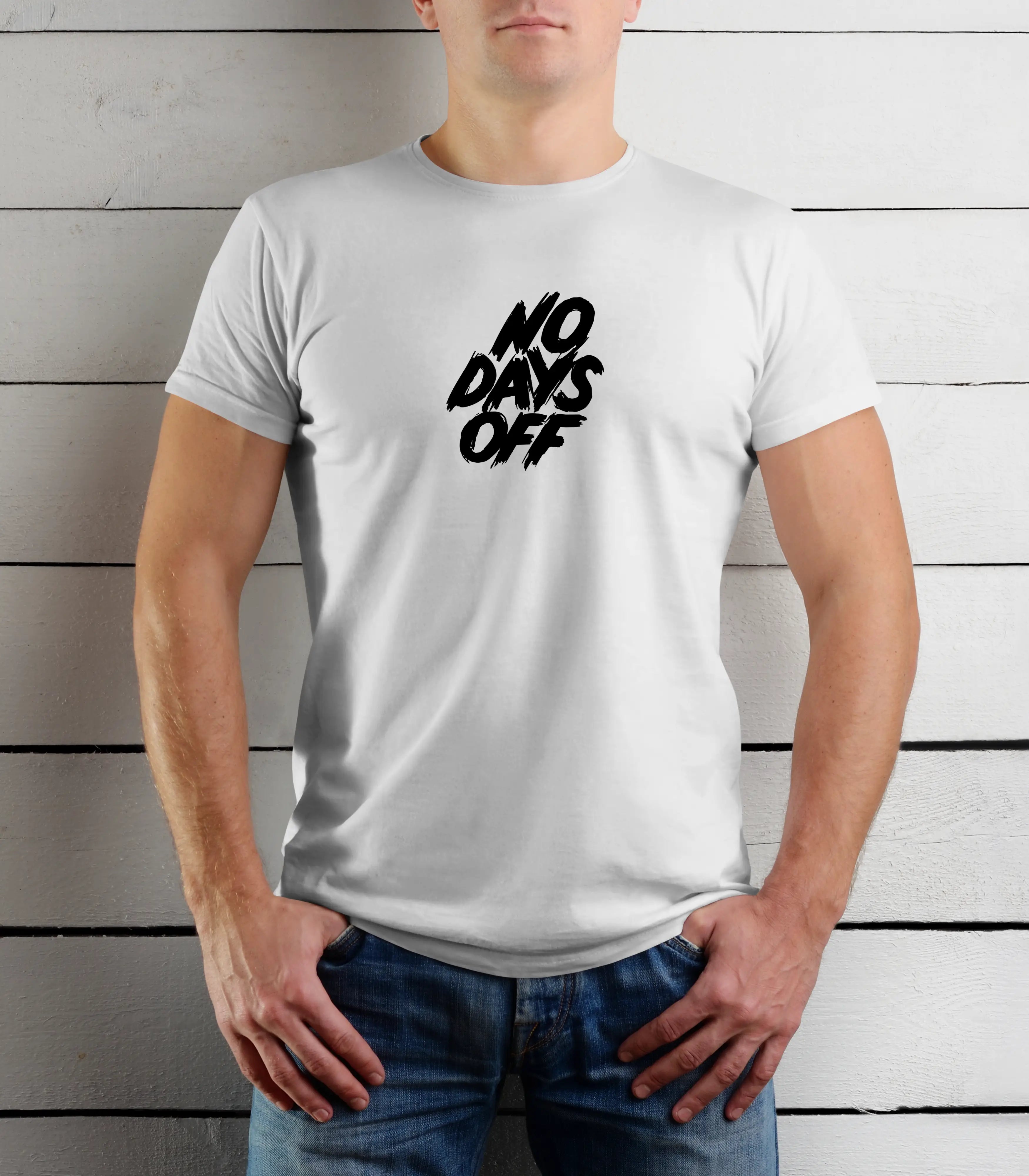 Person wearing a white t-shirt with 'NO DAYS OFF' text against a wooden background